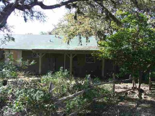 COUNTRY RUSTIC IN THE CITY. HIDEAWAY ON 1.88 ACRES. LARGE COVERED FRONT PORCH . LIVING AREA HAS MASSIVE ROCK FIREPLACE AND CATHEDRAL CEILINGS. WOOD SHUTTERS ADD CHARM. INCREDIBLE AMOUNT OF STORAGE IN THE HOUSE. LOTS & LOTS OF MATURE TREES SURROUND THE HOUSE.  GREAT LOCATION.
