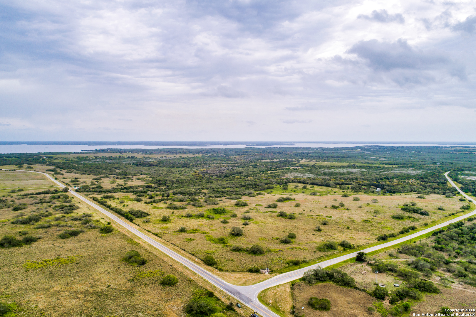 Developer's dream....Over 4200 ft on one side of property along FM 534 and 0ver 2800 ft of road frontage on 2nd side of property on Farm to market road FM 534.  La Garto creek on one part of property for fantastic hunting and recreation.  Hill top views, Mathis lake (Lake Corpus Christi) with a mile of the property.  Ag valuation in place, fantastic home with ample room, large barns, implement sheds and outbuildings.  No restrictions.  Multi use potential.