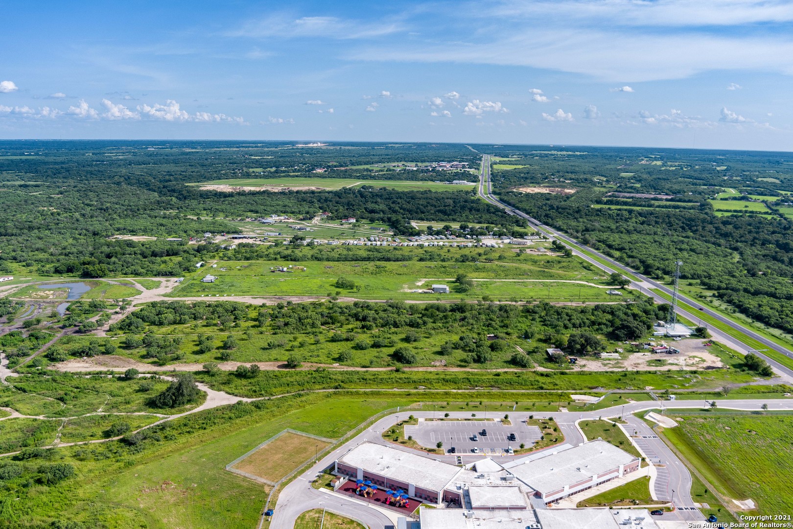 Add this Property 10 Acres located on Hwy 281 with 286 feet of frontage    your portfolio! Navistar International is approximately 1/2 mile north of the property.  Perfect for the next Vendor to build their warehouse. 10 Acres located on Hwy 281 with 286 feet of frontage.   Located 18 miles from the San Antonio Airport.5 miles south of 410, 3 mies from the Mission Largo Golf Course.  Zoned OCL with NO Flood zone.  Owner has an active Well and Electricity. access to city water and 5G right outside the property.  Currently used as a Construction office.  City water is located 5 feet outside property.  Owner has guard dogs pls call to view property.