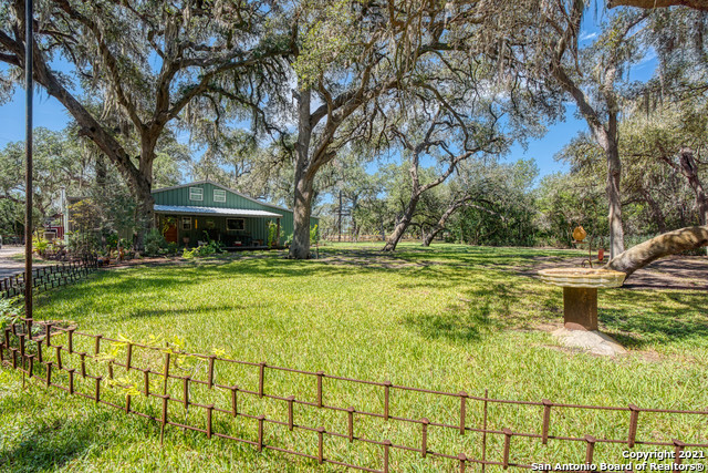 Imagine experiencing nirvana while spending picture perfect evenings nestled under the cool shade of the large oaks and elms covered with Spanish moss spanning the property. This property is perfectly secluded off a dirt road while the winding driveway leads you through the property to the custom built three bed, two 1/2 bath, two story 2100 sq ft barndominium. The 20+ acres is the combination of three tracts of land where you will find two ponds stocked with fish, the front pond has a zip line and bridge over the pond so you can cool off on those hot summer days. Everything about the property exemplifies the freedom and simplicity of country life. Enjoy working in the large shop attached to the barndominium or expansive storage space provided by the two barns. Cultivate your green thumb in the green house and transplant those blessings to the large garden. Reap your garden rewards and enjoy the fruits of your labor around the large center island in the kitchen. Enjoy farm fresh eggs gathered daily from the chicken coop, there are enough chickens, quail, ducks and geese to keep your family fed for a lifetime. The deer blind at the back of the property provides ample amount of opportunity to harvest your own deer or wild turkey that roam freely throughout the land. On those cold winter nights bring the family inside to build memories around the wood burning stove or simply relax in the clawfoot tub in the large walk-in shower. The town of George West is less than 10 minutes away, the property is 1 hour south of San Antonio and just about an hour away from Corpus Christi, TX. There is a small airport just minutes from the home where you can land your private plane. Boat ramp access to the Nueces River is just two miles away where you can fish for catfish and white bass. Choke Canyon Reservoir is 20 minutes away with world class largemouth bass fishing and duck hunting. This property will not last long! Book you private appointment today to experience the joys this property has to offer.
