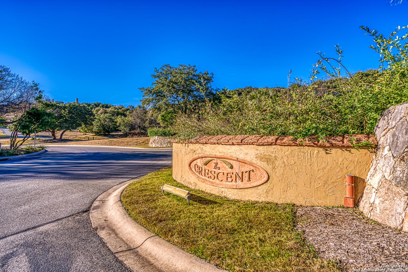 One of the most desirable and prestigious addresses in The Dominion. The Crescent is home to San Antonio's most stunning and iconic homes and this only available lot offers unparalleled views to the Hill Country. Located at the near epicenter of The Dominion this homesite can lend itself to a sprawling single level or go vertical for even more impressive views.  You can bring your own builder and there is no time constraint to build. The current owner has already invested in a fully enclosed (minus one small area) hand made wrought iron railed fence coupled with Cantera stone pillars with dedicated electrical drops at each pillar. Perfect for holiday lighting. Also you will see a stunning fountain and living area that was created. The design can compliment this look or perhaps your builder can make some easy changes to the look so it could compliment your design.  The Dominion neighborhood has controlled 24/7 guarded access with lots of amenities including Pool, golf course, club house and much more. (Sports and club require separate membership)