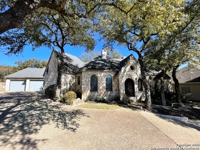 Custom built house by Bill Cox, prestigious builder in San Antonio. It has gorgeous exterior, straight from a story book castle.  Located in prestigious, guard gated community of Emerald Forest. The beautiful interior provides two huge master bedrooms each with its own bathroom. One bathroom has a chroma-therapy tub and built-in television to view from the tub. That bedroom also has a gas fireplace.  There is an additional 1/2 bath in the common area.  Open plan concept with a big living and dining room; a gas fireplace faces both areas.  The kitchen is a dream for a professional cook, 6 gas burners stove, a huge island, warming drawer, wine refrigerator, built-in stainless-steel refrigerator, and a trash compactor.  The stove area has custom rock that outlines it.  The patio has a custom deck that extends the living space.  Sound system throughout the house and patio, central vacuum system in the house.  Beautiful oak trees and xeriscape landscaping.  This is an exclusive property!