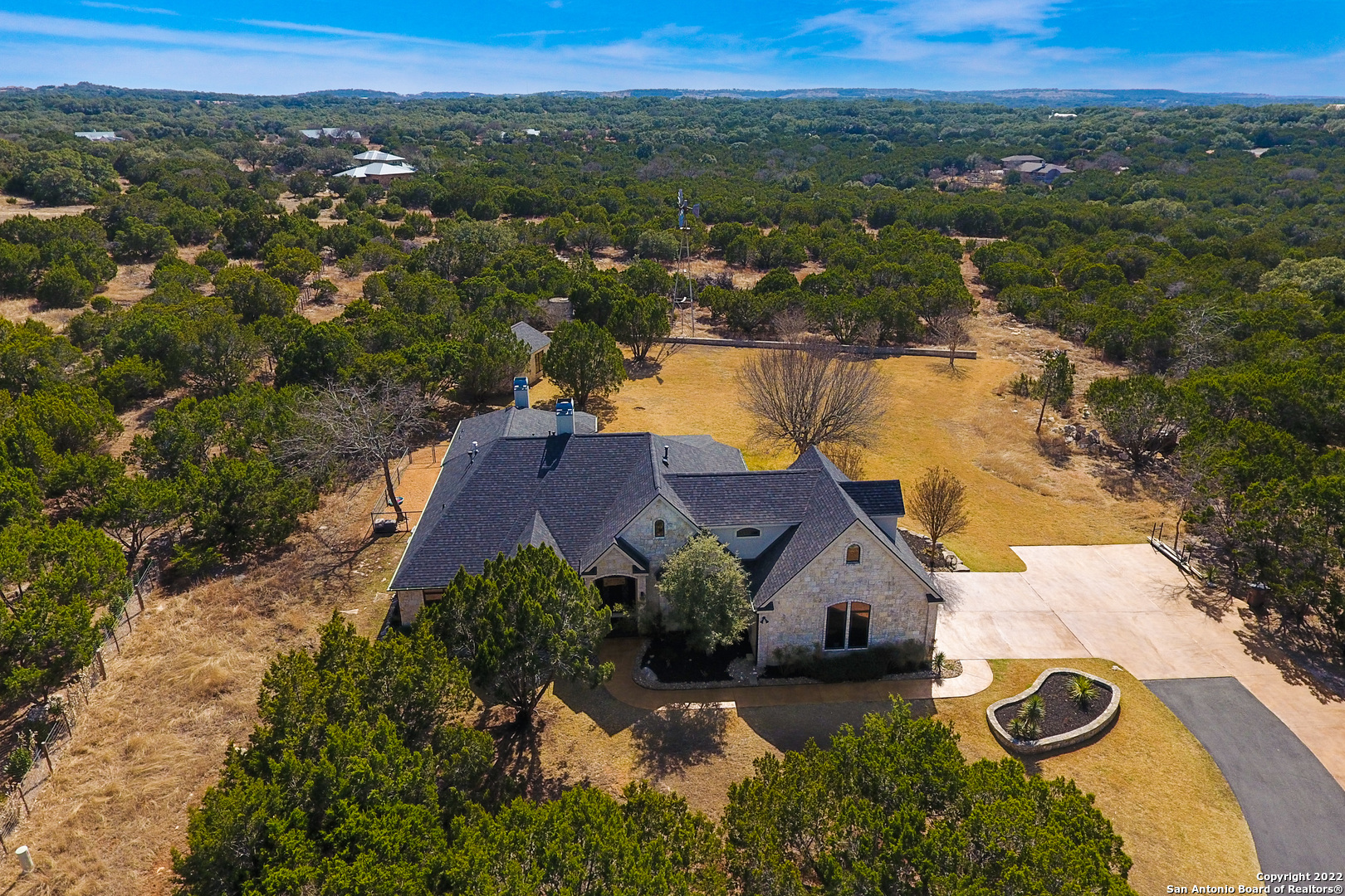 Wow! Best house in Cordillera Ranch for the money. Significantly reduced in price. Take a look at this completely remodeled Texas Hill Country Gem located in the award winning, gated community of Cordillera Ranch in Boerne, Texas on 4 private acres.   This custom home with 3,435 SF has been completely updated by the current owner over the past two years.  There is a 575 SF private, fully functional apartment/mother-in law suite above the garage that offers so many options (college student, mother-in law, guests, etc.).  The list of renovations is too long to mention, but some of them include new HVAC systems, new black high-end composition roof, extensive hardwood flooring, custom brick ARTO tiles in living room, all new Pella windows, all new custom cabinets throughout, stainless steel kitchen sink w/ copper finish, gas range, antique sliding barn doors, double sliding Pella doors leading to back covered patio that also offers custom tile flooring. The kitchen island is massive with cabinets underneath on both sides. There are custom shades in many rooms of the house. Shiplap is also installed in several areas of the home. The expansive, irrigated backyard leads to miles of hiking trails in the back of the property. In the backyard is a 12x20 (approx.) stone building with air conditioning, electrical, and plumbing that could be used for a variety of applications. It is not finished out on the inside. Located at the end of a quiet cul-de-sac, the gated driveway was recently stained and sealed.  If you are in the market for a stunning & recently renovated custom home in one of the finest Hill Country communities, you need to put this one on your list! Refrigerator does convey.