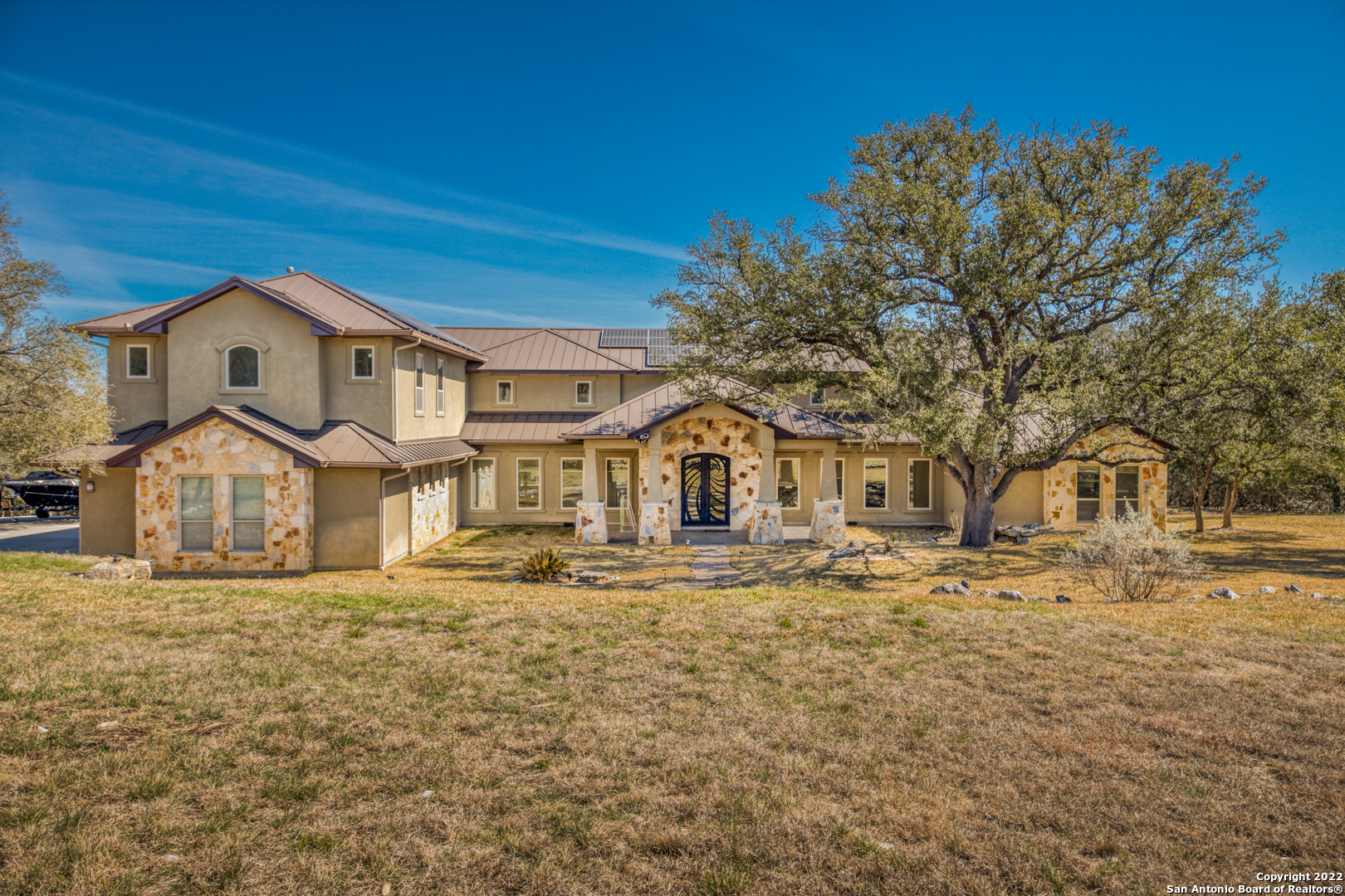 Come view this Beautiful, contemporary, well kept home in the heart of the hill country in person! This unique home sits on 13 Acres, 6 bedrooms, 5 baths, open floor plan with high ceilings, beautiful kitchen, grant counter tops and built in fridge. Primary bedroom does have an upstairs office with  Custom Built in shelving, and huge primary bath. This home has a zip line installed from from your private park, to the gorgeous pool! The outdoor patio area is your private oasis ready for family gatherings and memories. This home is equipped with solar panels, a irrigation system, one year old A/C  and so much more! Schedule your tour today!!