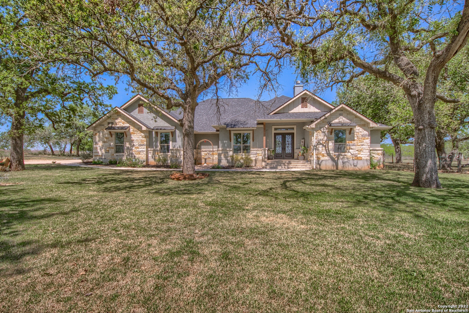 Elegant custom designed home in the country with details for days! This 2019 custom built home is a Stunner with so many extras!! On a 1.5 acre tree filled lot, this property has the potential to expand with an additional 11+ surrounding acres! With 2,890 livable sqft this 4 bedroom 3.5 bath home is exquisite and boasts a very large back yard covered patio ready for entertaining! The back patio has a beautiful wood burning rock fireplace, is wired for TV, and is already stubbed for gas for your future outdoor kitchen! In the spacious master suite you will find tray ceilings, back porch access, & beautiful french doors. Beyond the french doors lies a showcase full bath including garden tub, walk thru shower, separate vanities, his & her double walk-in closets, and bluetooth system for music, lighting, & exhaust fan. And talk about a showstopper kitchen with double islands, double convection wall ovens, gas cooktop, and a huge walk around pantry with tons of storage! Other features include: barefoot grass, beautiful landscaping w/ sprinkler system, separate office, guest suite with outside access & full bath, side yard fenced off for animals, wifi, additional storage unit with A/C & electricity, additional 300 ft. water well, exterior LED lights, large utility room with sink & mud room.