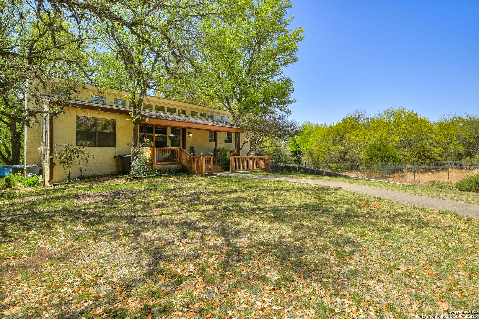 You don't want to miss out on this fantastic home in heart of the Texas Hill Country!  This home is full of charming accents like arched doorways, french doors, and built-ins!  There is an open kitchen with stainless steel appliances that looks out onto the front room.  New owners will love to sit in the sunroom with the large widows.  A covered back porch makes for a perfect place to watch the sunset.  The sprawling wooden deck lines the pool and has plenty of room for outdoor dining and sunbathing. Boerne Schools, easy access to I-10. This home was created with an inlaw suite in mind, primary living is on the main floor, down stairs is the inlaw suite, with a kitchen, living room, florida room off the primary bedroom with access to the patio.