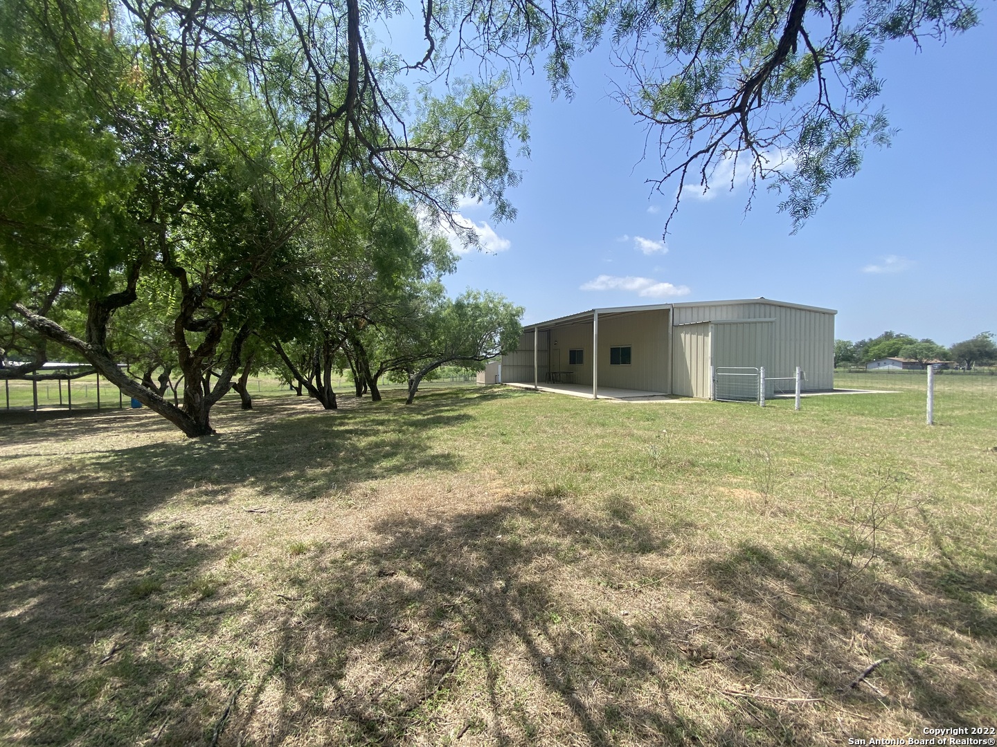 One of a kind 10.61 acres with 30X40 clean metal building to stretch out on! Build your dream home, bring a manufactured home in or finish out the metal building for a barn dominium! Minutes from San Antonio, City Base, Floresville, and Calaveras Lake. 2 septic tanks, working water well with cistern. The metal building has 2 HVAC systems (1 electric & 1 Propane) 1 window unit. Large gazebo and side porch. Small shed. There is also a tank (can be stocked with fish, is dry right now) on the property. If you want to stretch out a little more there is 10.61 acres (track 2) behind it for sale. Check the FEMA Flood Zone. Part of the property is in the 500 yr. flood zone. Hurry don't miss out the possibilities are endless!
