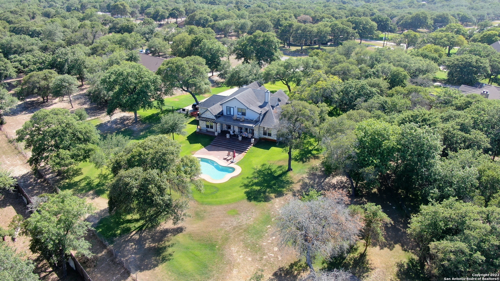 Located in Legacy Ranch Subd,No Hoa dues or City taxes,Low 2% Tax rate in the Sought after La Vernia ISD,Wilson County  *Very Clean* 1-Owner 4077SF Custom Built 1.5 Story 4-Side Rock Hm on a Fully Landscaped 1.4 Acre lot w/ a Cody Blt Ingrd Pool w/Spa (250 gal buried propane tank for pool/spa heater & cooktop in kitchen) Approx $30k Water Well for Front & Back Yard Sprinkler System/Landscaping (Water meter from SS Water Co for House) Fully Fenced Backyard,47x11 Covered Patio that Overlooks THE Pool,38x22 Finished Out Side Entry 3-Car Garage w/insulated doors *DOWNSTAIRS* has an 20x18 Master Bd AND 2 Or 3 More Bedrooms or Study w/Walk in Closet & French Doors,Spacious Island Kit w/Xtra Tall Custom Cabinets,GAS Cooktop,Blt in Oven & Microwave,Butlers Pantry,B'Fast Nook AND Formal Dining Rm or 2nd Living area *UPSTAIRS* via the Deco Wrought Iron Staircase is a Bathroom,20x8 Closet/Storage Rm,32x22 Gameroom OR Bedroom w/Outside Access to the 30x12 Balcony w/Tiled Flooring that Overlooks Pool/Backyard,HM has 2-Upgraded A/C Units,Sec Sys,2-Water Heaters,Transom Windows for Natural Lighting,French Doors,Rain Gutters,Lots of Crown Molding & Raised Deco Ceilings,Travertine Flooring,Water Softener,Pipe Fencing,GVEC Electric Services & FIBER OPTICS INTERNET,Again 1-Owner Very Clean Custon Blt Rock Hm that Shows like a MODEL HM