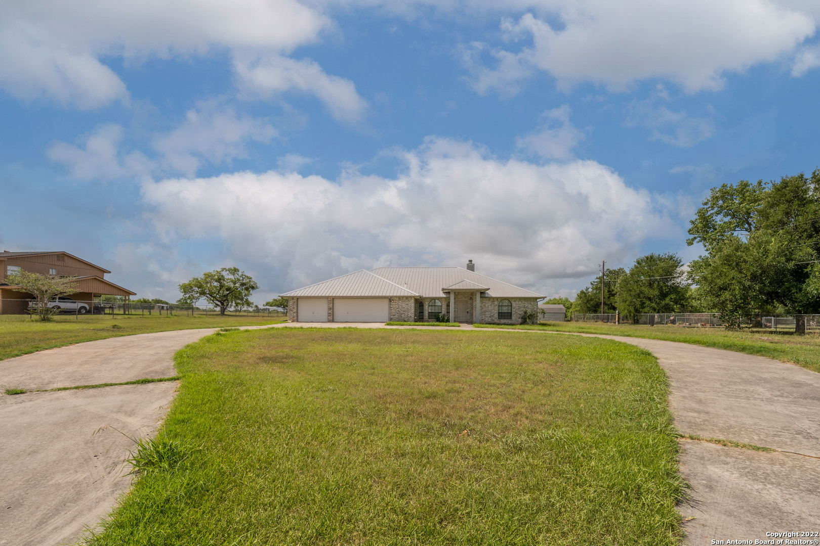 Need space?  Come see this one. Nice, single-story home. 5 bedrooms, 2 baths, 3-car garage, gated property.   An additional room can be used as an office, gym, game room, etc.  Sitting on approximately 10.09 acres. The home sits on 1.71 acres, with 8.38 additional acres in the back with a pond.   The back section can be used for cattle or horses.  Two storage sheds in the back; one large and one small.  Bring the chickens and all.  This is a great setup for the farm.