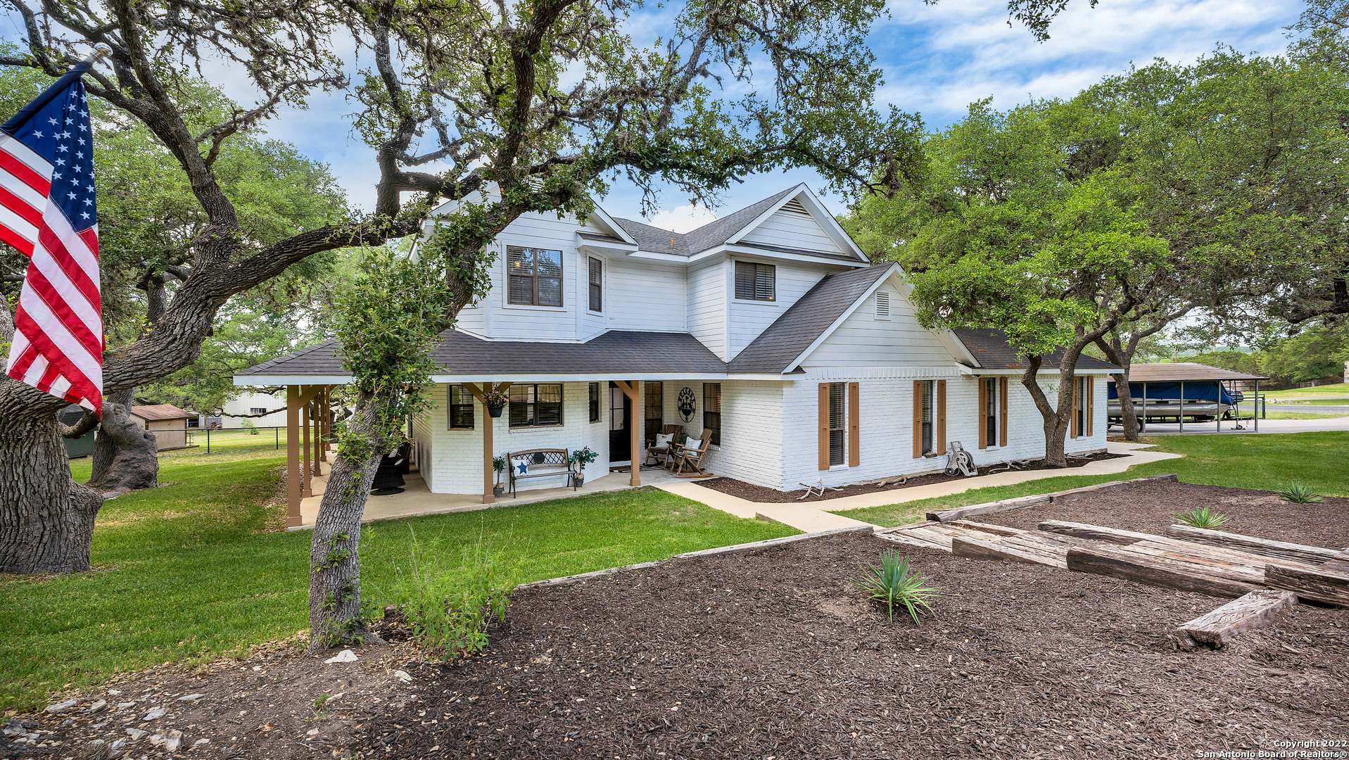 This piece of the Hill Country close to perfection -- at just under an acre and strewn with mature oaks, there couldn't be a better place to hang a swing.  The long, inviting porch is the ideal place to enjoy your morning coffee while listening to the birds sing.  Inside you'll find a unique layout that includes a mega-flex room that is currently set up as a media room, office space, and guest bedroom, all separated by barn doors. Be sure to notice the wood-look tile, unique lighting fixtures, updated hardware, and the newer kitchen appliances. Discover a hidden spot in the laundry room closet suitable for storage, a safe, whatever you can imagine! OPEN HOUSE SATURDAY JUNE 11, 1:00-3:00!