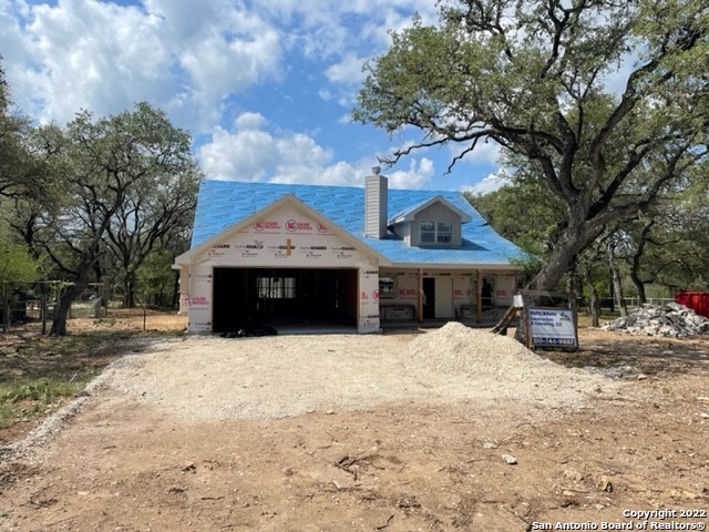 Wonderful Custom Home on 1/2 Acre in Bandera TX! 24 acre river park, Pool, tennis and basketball courts in Subdivision.  Step into this open floorplan with soaring ceilings and attention to detail. A beautiful custom home with a large front porch, and a covered patio that backs up to a 400 acre ranch.  The home features a large downstairs master bedroom with a huge closet and outside access. The master bath has a separate corner tub and great walk in shower.  The kitchen has granite countertops, stainless steel appliances and Gas Cooking!   Fully featured home with native fieldstone accents, metal roof, mature trees and a fully floored attic!