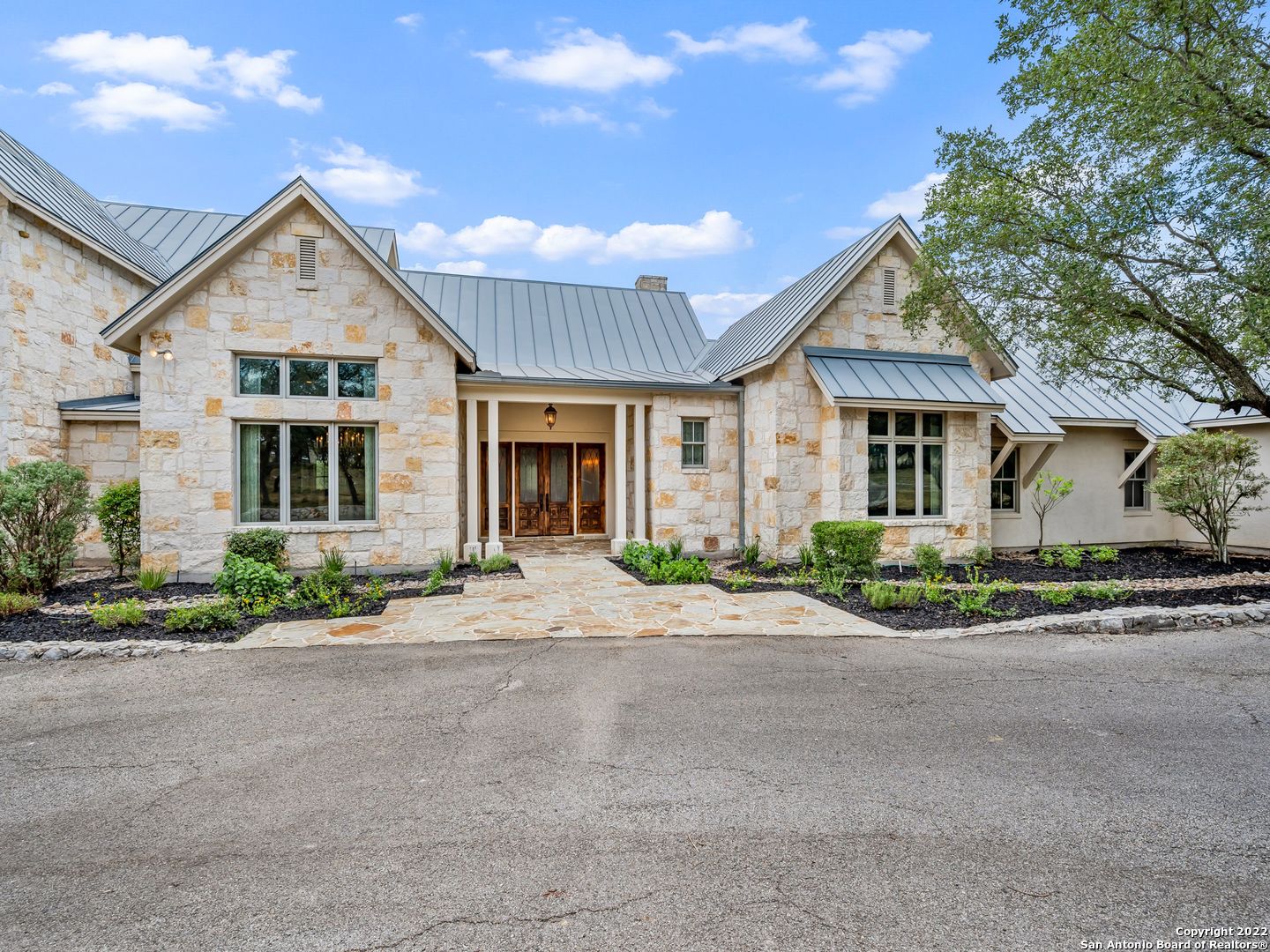 Handcrafted Texas Hill Country estate meticulously designed by Mac Chesney and built by Michael Scholl. Extreme privacy is exemplified once you enter through the guarded gates of Greystone, then through your own private gate within your residence. This estate finds the perfect balance between luxury and functionality. Unsurpassed craftsmanship and materials are harmoniously combined to create stunning living spaces. Hand selected with only the finest appointments throughout to include hand scraped hard-wood floors, custom ceiling and architectural details throughout, custom solid wood cabinetry and exotic stones & granites. The chef's kitchen features professional grade stainless steel and an oversized granite island / bar stool seating. The master suite boasts a spa-like bathroom with His & Her closets and an exercise room. Impeccable craftsmanship prevails with a guest bedroom on the main level with en-suite bathroom and two spacious guest bedrooms found up with a large game room. The expansive outdoor paradise flows harmoniously with extensive decking and hardscaping, Keith Zars pool & spa, full outdoor kitchen all within a screened in patio.