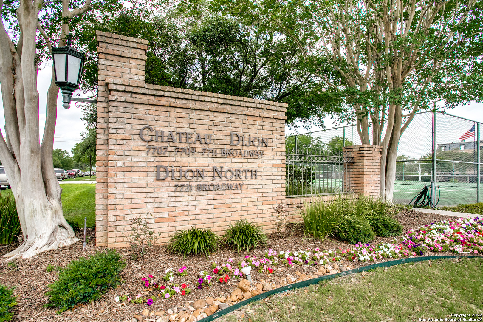 Experience the ultimate in urban living at the prestigious gated community of Chateau Dijon. Resident amenities start with New Orleans style brick buildings, a park like setting with towering oak trees and beautiful manicured landscaping, on-site management, security cameras on property, two resort size pools, tennis courts, dog park and ample guest parking. The pedestrian-friendly lifestyle offers convenient shopping and restaurants venues along the Broadway corridor as well as close proximity to the Pearl District, museums, cultural events downtown, the airport, Fort Sam, Trinity University and the University of Incarnate Word and Loop 410/Hwy 281. This remarkable, renovated condominium home is all on one level. Modern, light and bright, the open living area and kitchen is always ready for your entertaining or relaxation needs. The stunning primary retreat offers a private spa quality bath with granite counters, separate whirlpool tub and large walk-in shower, dual vanities and oversized walk-in closet plus a sitting area. The guest bedrooms each have an en-suite bath. Interior features include a refurbished gourmet island kitchen with granite counters and high end SubZero and Bosch appliances, upgraded guest baths, enhanced lighting, hardwood floors, coffee or wet bar, utility room with tremendous storage, updated wiring, recently replaced HVAC units and addition of double pane windows. Easy access by elevator or stairs to accommodate residents or guests on this second floor unit. Expansive, private balcony offers peaceful courtyard views. Three car reserved covered parking with exterior storage.
