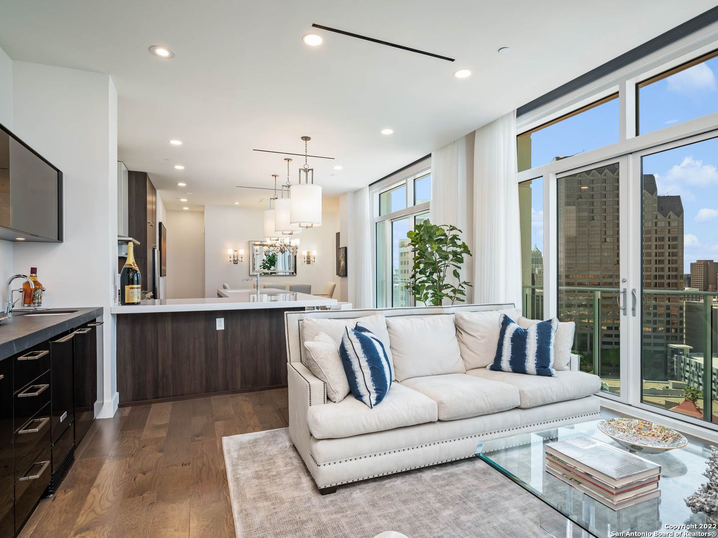 This customized residence has phenomenal downtown views through the floor-to-ceiling glass with sliding doors. With 10 ft ceilings, this 2 BD | 2.5 BA | 1,694 SF Cezanne floor plan is loaded with upgrades. The space is inviting and ready to host, with a wet bar, wine refrigerator and ice maker in the living room bar. The chef's kitchen has a grand island with thick quartz countertops, a pullout pantry, high-end Thermador gas stove, and to-the-ceiling cabinetry with upgraded hardware. Custom finishes include light fixtures, motorized shades, and curtains. The owner's suite has great views and customized closets. This residence is being offered furnished, if desired. Located above the Thompson Hotel, amenities like 24-hour concierge, valet parking, and optional housekeeping and linen service offer a low-maintenance lifestyle. Residents have full access to the Thompson pool with cabanas, bar, and cafe. The hotel spa has a steam room and sauna and offers in-home massages. Other services available include dog walking, car detailing, personal shopping, housekeeping, linen service, and dry cleaning. While LandRace offers riverside seating downstairs, The Moon's Daughters has rooftop dining and cocktails upstairs. Located on a quiet part of the river next to The Tobin Center for the Performing Arts, residents enjoy preferred access and ticket purchases to all shows at The Tobin. Come experience The Art of Living Beautifully.