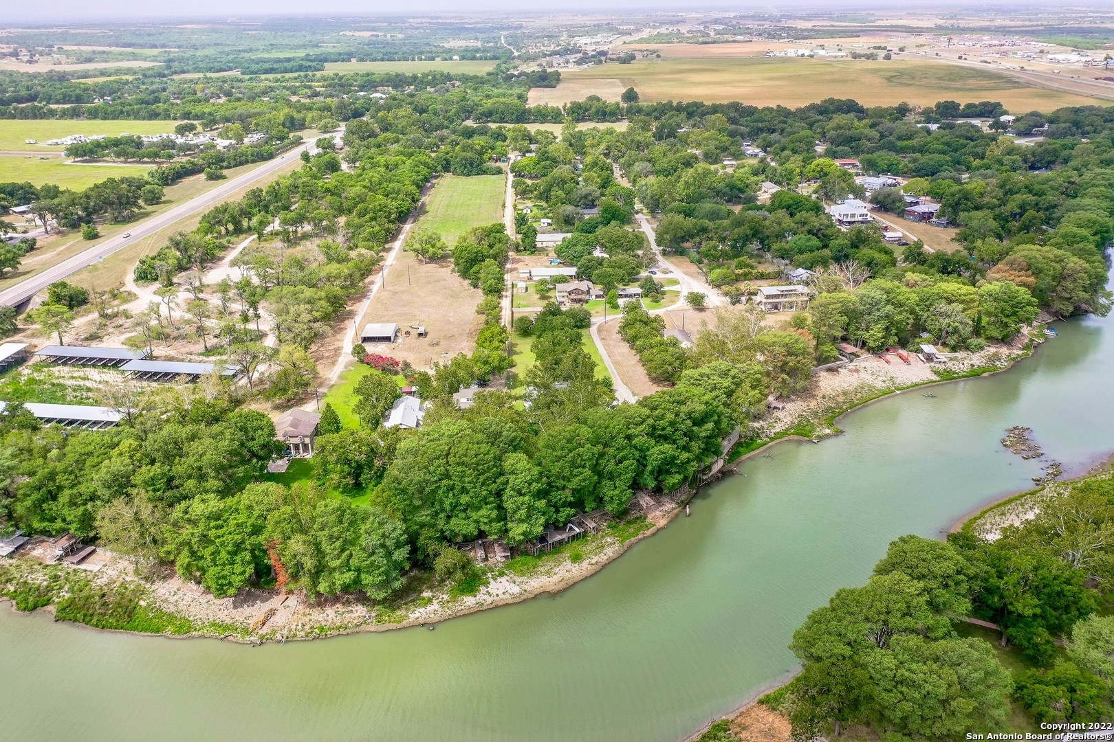 WATERFRONT LAKE PLACID 2-story home w/ private road gated access off Reiley Rd & approx. 60' of river front access w/ 2 docks along the Guadalupe River.  Home was lifted in 2019 above flood level FEMA recommended contractor (see attached documentation). Roof replaced 2018, completely new AC & Septic systems installed in 2019.  Approx. 800sf detached metal garage shop.  Reside full time on the river, great weekend hideaway or short / long term rental, the possibilities are endless!