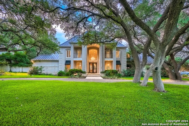This unique house in Shavano Park sits on a private one-plus acre lot with large, mature oak trees. The house was remodeled and is decorated in a classic contemporary style. A new metal roof was installed 2 years ago. The outdoor kitchen was fully remodeled 1 year ago. This estate property features a side entry 3-car garage and separate circular driveway. A large living room with fireplace overlooking the pool patio. The living room has an 18-foot high ceiling, providing light and spaciousness. A bar console and a cozy sitting area create a nice extension to the living space. Next to the living room a family room with fireplace and TV also overlooks the private backyard.  If you are not into TV, the views from the family room are so spectacular that you can easily get entertained by the nature show in your own backyard. Large modern home office with double doors and custom built-in desk, shelves, and cabinets for the work-at-home executive. Spacious owner's bedroom suite with fireplace. Custom en-suite features a large spa tub, separate shower, dual walk-in closets with custom shelving, towel warmer, bidet, and separate marble vanities. Extra exercise space with installed mirrors for yoga and fitness routine. Refinished oak wood floors throughout the living room and the entire first floor. A fully remodeled chef's kitchen with Viking appliances and breakfast room boasts a large 6 burner gas cooktop island and breakfast bar. Built-in Thermador refrigerator, beautiful granite counters and custom cabinets, microwave, two stainless steel sinks, and swing-out TV. While you cook, your guests will be mesmerized by the fish in the custom, 90-gallon aquarium. A separate dining room is a perfect size for entertaining. Custom faux painting in the kitchen, dining, living, gameroom, and master bathroom. The spacious utility room on the 1st floor has extra cabinets, counters, a large sink, and a closet and serves as a perfect extension to the kitchen and a gateway to the back yard. A full guest bathroom next to it is designed to serve as a convenient shower after pool/spa time. A huge gameroom with sound-absorbing cork flooring for movies, poker, pool, games. It includes a custom wet bar with sink and beverage refrigerator. Plenty of bookshelves and storage space. One of the bookshelves opens to the hidden "secret room" with a large storage area. Bedroom 2 could be a mother-in-law suite with its own bathroom. Bedroom 3 also has its own  bathroom, workspace, and balcony. Bedroom 4 has a private balcony. Bedroom 5 has two closets and has views into the backyard. The outside kitchen features new granite counters, built-in grill, a sink, and waterproof cabinet storage. Additional features include plantation shutters, gutters, surveillance cameras, Sonos sound system, water softener, hand-crank windows, 4 zone HVAC system with HE filters, and 2 water heaters. Home faces West providing extra energy efficiency and outdoor enjoyment. This home is well-loved and cared for by its owners and it's ready to serve as a peaceful sanctuary to a new owner.