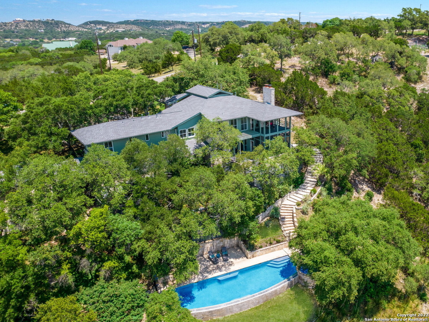 Contemporary Hill Country Masterpiece! This custom home designed by Award Winning Austin Archcitect, Tim Cuppett, captivates with an understated, sexy sophistication. The refined, timeless style is well-executed to complement, and not compete against the alluring outdoor elements, overlooking the Cibolo Creek and Canyon. Upon first step into the foyer, the soaring ceiling, brilliant architectural design and gorgeous hardwood maple flooring create an instant WOW factor. And, let's talk about the aesthetic charm of all the wood-framed windows!!! The split-level layout allows for opportunities to enjoy the beautiful hill country from almost every room! The great room includes a full limestone wall & fireplace with space for several conversation areas. The dining room is open to encourage a relaxed & enjoyable ambiance. The sleek galley kitchen boasts long granite counters, 2 sinks, stainless appliances including a Thermador 6-burner gas range with convection oven. The master suite features a gas fireplace, full bathroom, walk-in closet & private balcony. The office possesses a lofty vibe, complete with built-ins, a corner window reading nook & is conveniently located near the master suite. The secondary bedrooms, bathrooms & living room can be found tucked away on other levels. The multi-tiered, hillside decks provide plenty of spots for coffee at sunrise, yoga, dinners al fresco & shaded evenings with drinks & entertaining. I dare you to find a spot that doesn't provide you with incredible, breath-taking views of the canyon! This gated property is near the end of a cul-de-sac, feeling hidden & private. No city taxes! Conveniently located between New Braunfels, San Antonio and Boerne.