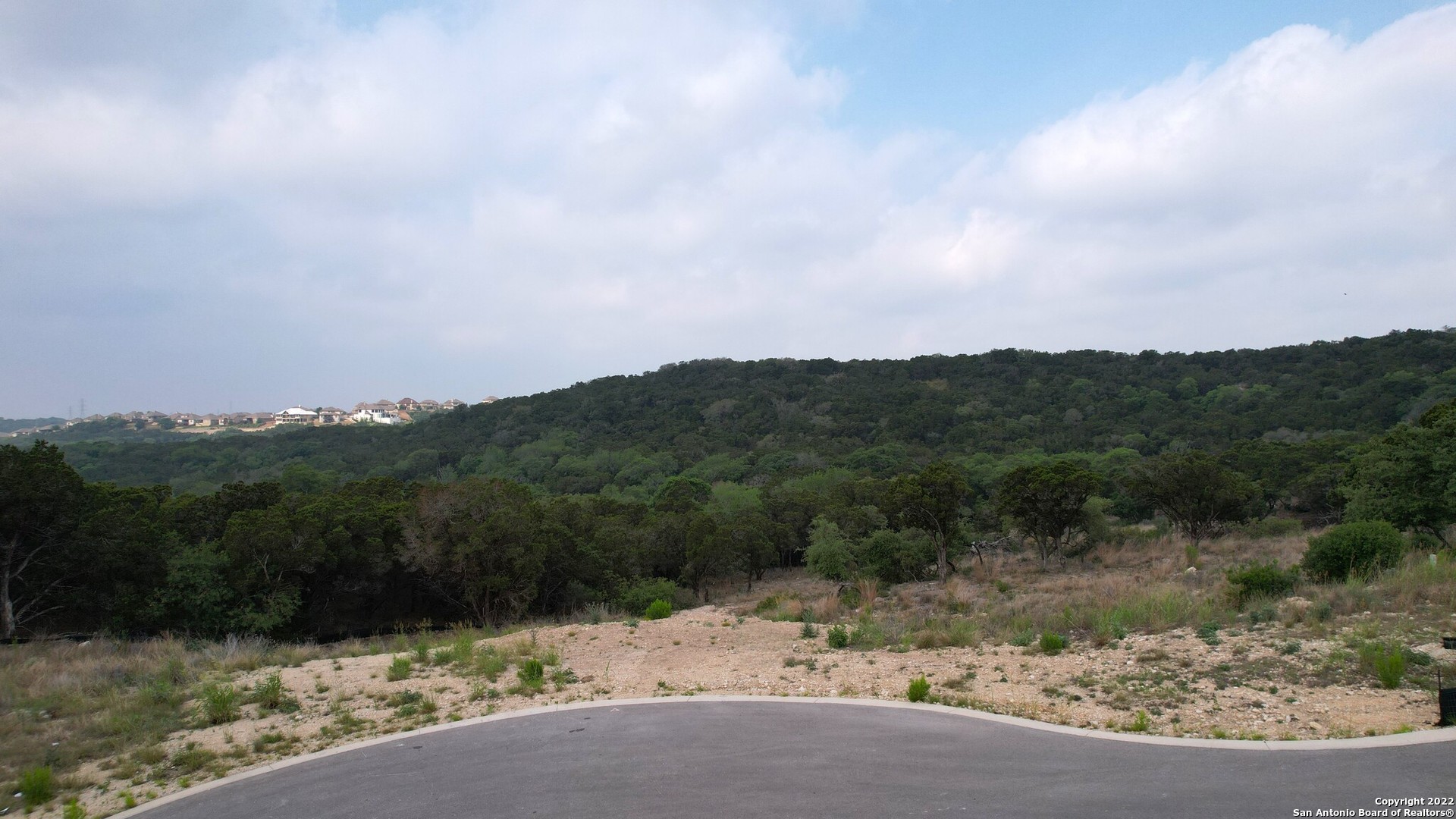 Rare opportunity. 5 acres! Build your dream home in the beautiful hill country with a valley breeze. Located on a cul-de-sac. Established neighborhood. Controlled access. North and West bordered by 7.4 Ares tree conservation. 80 acres Crown Ridge Park to the South. Valley views of parkland. Complete Privacy of 20 + acres with surroundings!! Follow green stakes to proposed building site with view. property line is roughly 40 ft past the old ranch fence. It is marked by several orange ribbons on tree limbs. Close to I10, shopping, restaurants, entertainment, 20 minutes from downtown San Antonio. Buyer to verify taxes, lot dimensions, school districts.