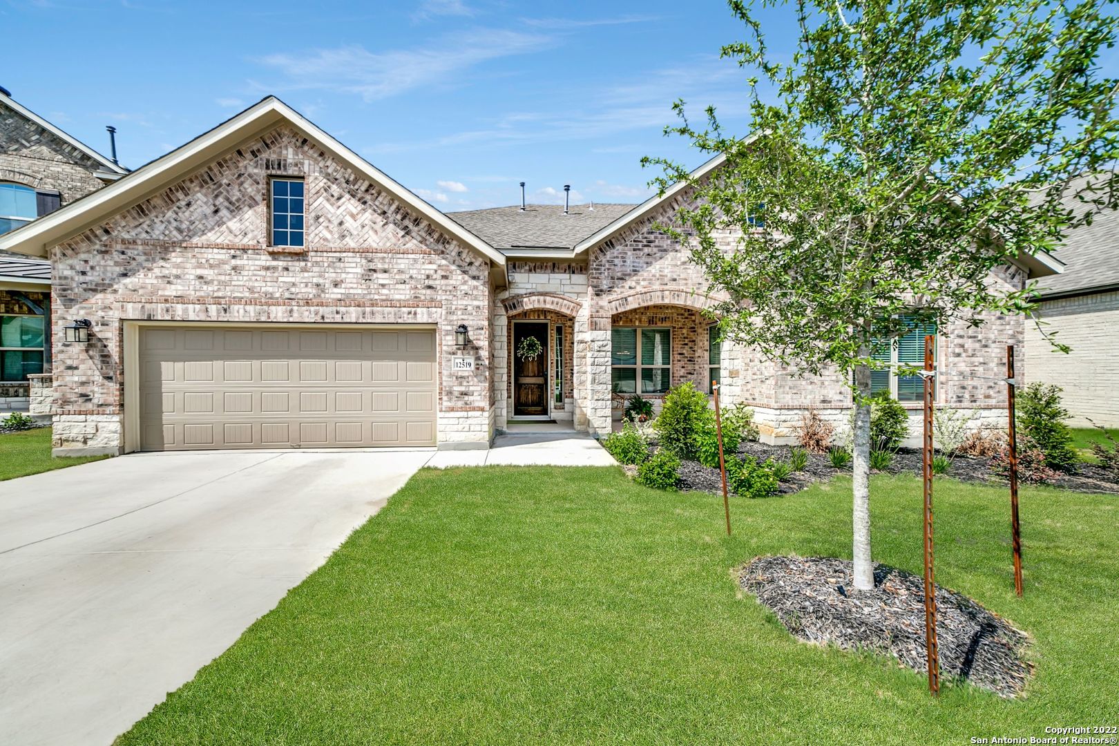 While some homes have curb appeal that are all hat and no cattle, this upscale modern hill country home in Fronterra at Westpointe has both (though you may have to peek out past your back fence to the greenbelt to see anything akin to actual cattle!). Picture yourself sipping ice tea on your welcoming front porch, waving to your new neighbors, before slipping inside through your tastefully rustic knotty alder wood front door to the cool interior-the Texas sun is no match for the UV block on these windows and AC pumped from dual units! Off the foyer, you'll find both a home office with glass french doors and a formal dining room with elegant crown molding. Light, wood-like tile and serene colors accentuate the bright, natural light of the home. Downstairs offers 4 bedrooms, including a spacious master with a tall tray ceiling, bay window, and spa-like bathroom. Home chefs will appreciate the open concept eat-in kitchen with a large island, bright, white cabinetry, granite countertops, a walk-in pantry, and built-in stainless appliances to include a gas stove top. The kitchen is highlighted by designer pendant lights and overlooks the home's centerpiece-a floor to high ceiling cut stone fireplace and hearth. A graceful wood and wrought-iron staircase leads from the living room to a game room and additional private guest bedroom upstairs. Additional custom features and amenities of the homes include 4-sided brick, a mudroom with separate utility room, a large covered patio overlooking a lush lawn (w/ sprinkler system), a water softener, and a tandem 3 car garage! This friendly neighborhood is convenient to 1604 and features a pool, playground and clubhouse.