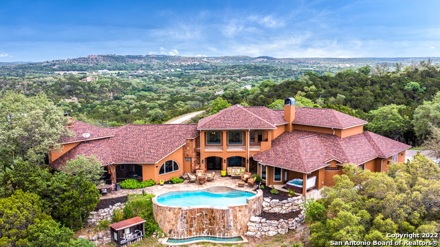 Stunning HILLTOP Dream Home! ~ Imagine Owning This ONE-OF-A-KIND Custom Home on Approximately 10 ACRES ~ Incredible Hill-Country VIEWS ~ Boasting 4500+ sq. ft., an ATRIUM, 4 Bedrooms, 3-1/2 Baths, MEDIA Room, Pool Table, Study, 2 Fireplaces, 4 Patios, HOT TUB, 4-Car Garage & Beautiful IN-GROUND POOL There is Something for Everyone ~  The Atrium w/LIGHTED TREE inside the Grand Entryway is Just The First of Many Features of this Beautiful Home ~ The Chef in the Family Will Appreciate the GOURMET GAS Kitchen Which Features COPPER Ceiling, COPPER Custom Cabinets w/GRANITE Countertops, JENNAIR Cooktop w/4 Burners & Grille, KITCHEN AIDE Refrigerator w/COPPER Panels, GLASS OCEANIA Kitchen Sinks, & Reverse Osmosis ~ Step into Your MASTER SUITE Thru the Custom Arched IRON & WOOD Door, Unique STONE Wall & STONE Fireplace w/PRIVATE ACCESS to the Hot Tub & Pool ~ The Gorgeous Master Bath Will Amaze You! Featuring SEPARATE Vanities, GRANITE Floors, Shower & Countertops ~ Step out the SAUNA & Relax Watching TV Which is Mounted Over the ROUND JACUZZI Bath Tub ~ 4 HVAC Units & 1 Window Unit in Garage ~ In Associated Docs The Owner Has Provided a Detailed List of the HIGHLIGHTS & Many IMPROVEMENTS Which Includes a New Roof in 2021 ~ DON'T MISS THE OPPORTUNITY To Share This WONDER w/Your Clients!***Please see more by looking at FEATURE SHEET in Associated Docs***
