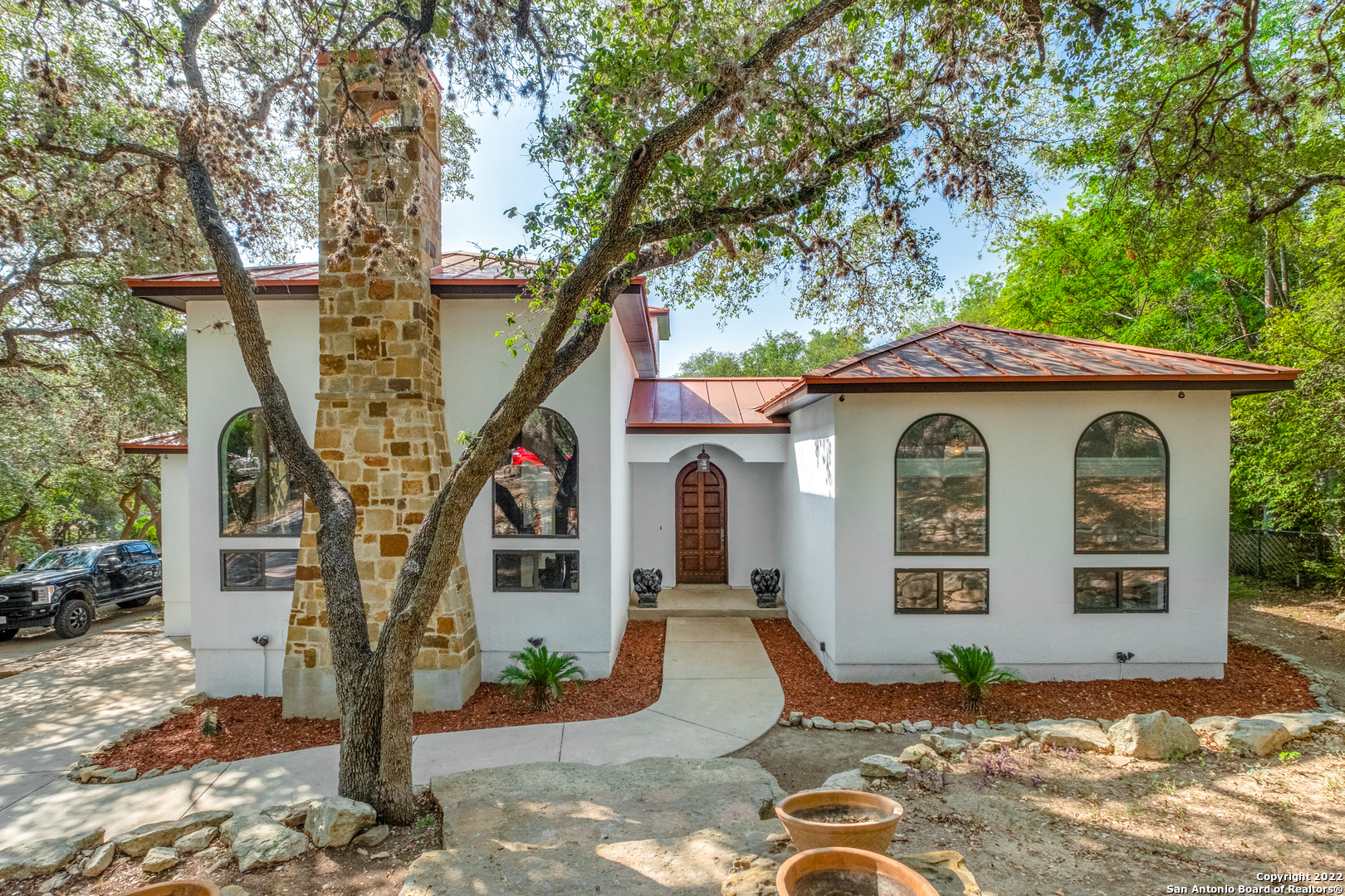 This beautifully renovated custom-built 4,147sqft home offers one-of-a-kind features that you will fall in love with and a kitchen that must be seen! Situated on a half-acre in a quiet neighborhood filled with mature trees, you'll enter through a hand carved mahogany front door into an atrium with in-lay flooring looking into a courtyard. To your left you'll find the first of multiple living areas with tall windows and a fireplace over 6 feet tall. You'll continue into the dining room, butler's pantry, and then a chef's dream with Thermador and Miele appliances, a leathered granite island, and plentiful cabinetry and countertops. You'll continue to another living area with white oak flooring and up a mahogany staircase to two upstairs bedrooms. The right wing of the home consists of a cathedral ceiling guestroom and primary bedroom with a 25ft long ensuite bathroom. There are simply too many features to describe here. Schedule your tour quickly!