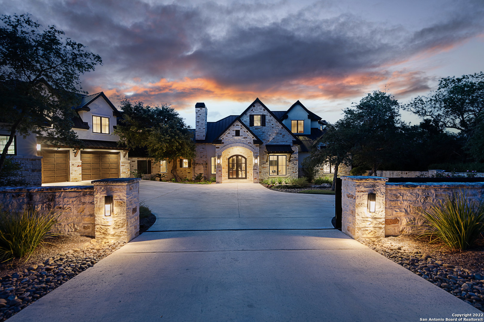 Nestled amidst the serene hill country awaits a grand estate with sprawling acreage and 206 feet of Guadalupe River frontage. Upon arrival, the privacy wall adds beauty and additional security while the custom-made gated entrance opens to unveil a home that embodies hill country living at its finest. Stepping past the double doors reveals an open floor plan complete with glistening hardwood floors, rustic yet refined rock accents and exposed Douglas Fir timber beams. Dinner parties and everyday living are made easy with the chef-inspired kitchen that features commercial-grade Wolf appliances, a custom Limestone vent hood, wine refrigerator, plenty of counter space for prepping and an easily accessible dining nook. After supper, retire to the cozy family room with a rock fireplace surrounded by a custom limestone hearth and mantle. When hosting friends and family, the backyard is an oasis for relaxation and year-round entertainment. Unwind in the elaborate heated swimming pool with spa, swim up bar and a 7.5-ft tall waterfall, craft a few s'mores around the fire pit, or recline on one of the many outdoor patios including an observation deck that overlooks the Guadalupe riverbank with outdoor living and cooking area below. This residence is the only Guadalupe riverfront available in Cordillera Ranch!