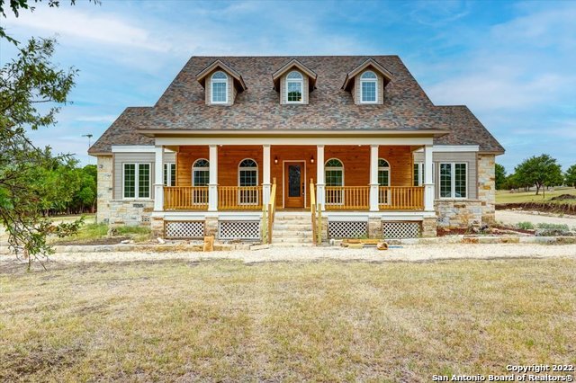 **Price Improvement** Well below County Tax Appraisal** Fantastic custom built home just steps to the Guadalupe River. Come check out this beautiful, well-built custom home on nearly 2 acres. The seller built this home and created a quality product. From the knotty-pine doors throughout, oak cabinets in the kitchen to engineered hard wood floors on the first floor. Check out the tongue and groove ceilings in the living room and porches. This home has two 18-seer HVAC units to ensure you stay cool on these hot summer days. Comes with a wifi thermostat. But, if you want to cool off and save on electricity, just take a short walk to the community park, where you have access to the Guadalupe River where you can BBQ at one of the provided pits and bring your chairs to sit in the river. HOA also provides a community pool and park. Kitchen features gas cooking, dual built in ovens and a built-in microwave. Or, if you'd like, check out the fireplace in the living room. Owner has a shelf built in where you can cook over the fire. He even included a hook to hang your pot. The fireplace has blowers that will keep the entire first floor warm. In addition, you can duct those blowers into the existing HVAC system for whole house heating. Master down with nice bathroom and spacious walk-in closet. The house comes with a Wifi water heater, water softner with filtration system and double pane windows that are crank out to open. Front porch is 34x8 and back porch is 24x6. This house is amazing. Come see it soon, as the seller has priced it below county tax appraisal value. It won't last long.