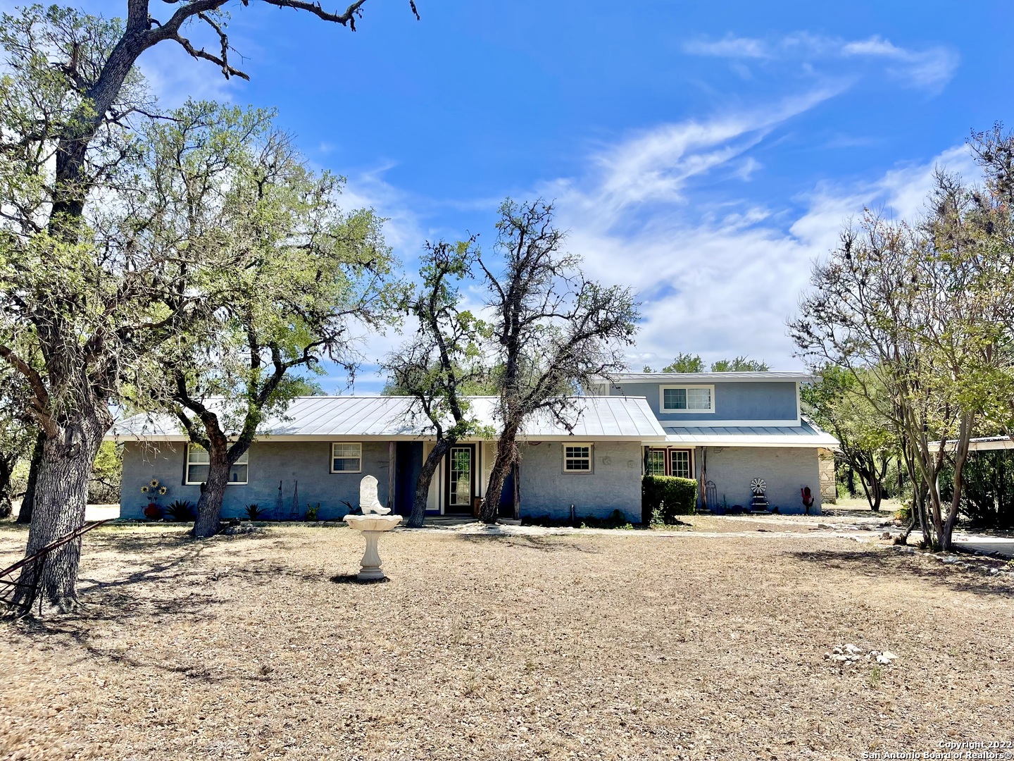 Looking to settle down in a small community? This TX Hill country 8.25+/- Ac property located in Medina, TX on the West Prong of the Medina River might be the one! The main house is a 2126+/- sq ft 1-1/2 story home that has 3 bdrm-3-1/2 baths. There is also a detached efficiency guest house, barn, and sheds. This would be a great property for livestock (recently home to several Champion Show Goats). The barns would support working on several different types of hobbies with a few modifications. With approximately 340'+/- of river frontage, there's a lot to do and even more fun to be had!
