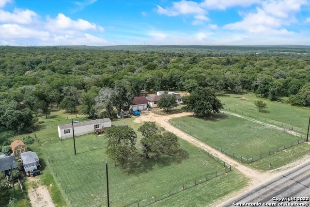 Over EIGHT private acres in booming Seguin Texas. Primary homestead has 2 bedrooms and 2 bathrooms with an office that can be used as a flex space or third bedroom with above ground pool. Detached garage. Gazebo. Outdoor airconditioned 10x10 shed remains as well as an additional 2 bedroom 1 bath mobile home with deck and ramp- perfect for all of your out of town guest/in-laws/etc. Perfect slice of country living- schedule your showing today! Family land aquired in 77' Family house built in 84' per seller.