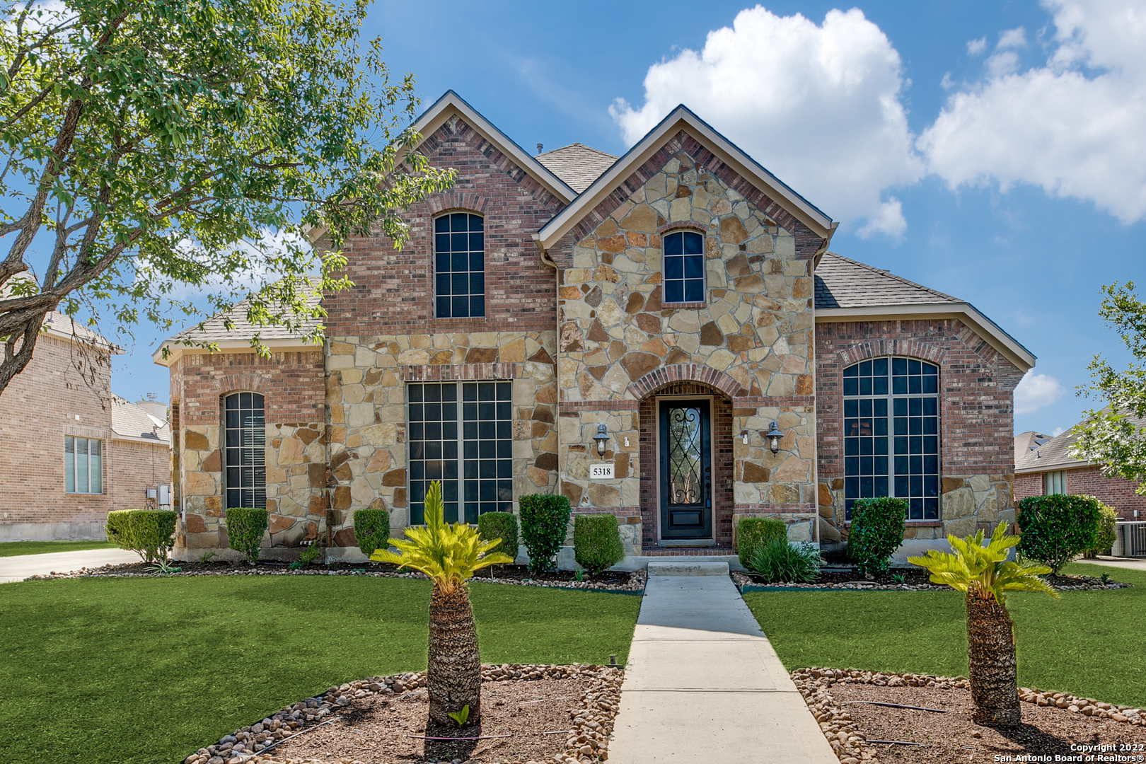 This gorgeous home is nestled in the prestigious subdivision of Alamo Ranch at the Summit. In the gated section, homeowners will appreciate the privacy and coveted access. Upon arrival, the stone and brick exterior creates unique curb appeal with delicate landscaping. Inside, soaring ceilings are highlighted by picture windows and natural wood flooring. The spacious living area offers a floor-to-ceiling stone fireplace, perfect for gathering with loved ones. The household chef will revel in the gourmet kitchen with an abundance of prep and storage space. Double ovens and gas cooking add convenience for culinary adventures. The breakfast nook and dining room allow for various opportunities while entertaining. The office offers French doors for added privacy. Retreat to the roomy primary suite with en suite. A secondary bedroom is suitable for a guest suite. Upstairs, a study space, media room, and three secondary bedrooms remain. The sunroom allows for enjoying views of the outdoors year-round. Send the summers in the glistening pool with a spa. In addition to all the home has to offer, a three-car garage is great for parking or a partial gym! Come see this home today before it's too late!