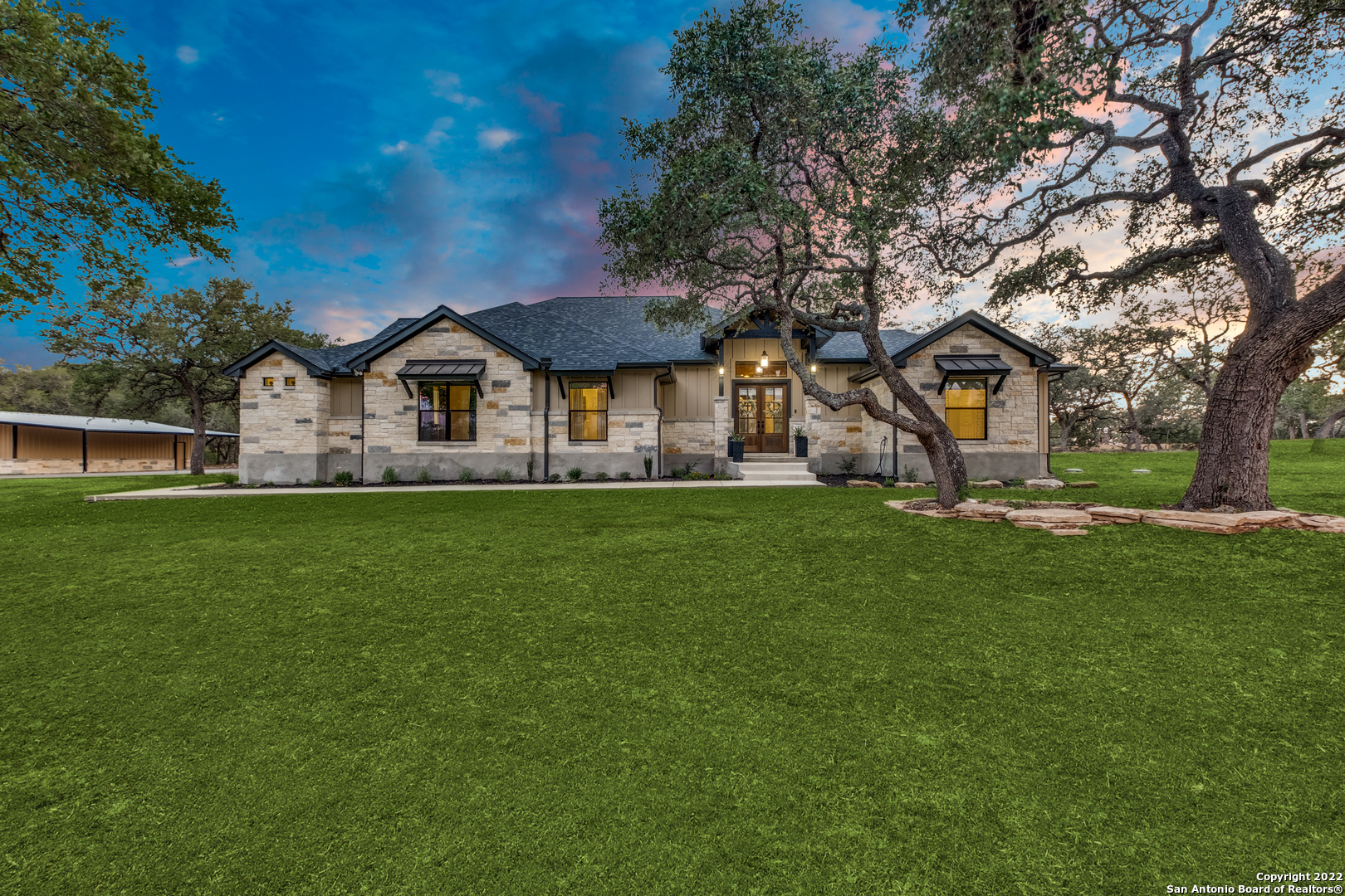 OPEN HOUSE SUNDAY JULY 3rd FROM 1-3! CALL HOLLY MAHLER FOR GATE CODE. Phone number will be at the gate. Stunning Modern Farmhouse style home with an OPEN FLOOR PLAN in Sabinas Creek Ranch, one of the newest and most desired GATED subdivisions of BOERNE. This ALMOST NEW home sits on over 8.5 WOODED ACRES on a cul-de-sac street and backs up to a large ranch. The home is situated in the middle of the lot so it cannot be seen from the road, plus it is surrounded by TONS OF OAK TREES for added privacy!  With all the windows in the home you will think you are living in a tree house! On cold winter nights, you will enjoy a fire in the floor to ceiling stone fireplace in the living room or a fire in the OUTDOOR FIREPLACE while keeping warm. In the evenings while relaxing on the large covered patio and watching the sun set, you will enjoy the distant VIEWS of the HILL COUNTRY.  As you enter the home, you will be overwhelmed by the openness and the high ceilings.   The home has 3 bedrooms, along with a STUDY, which could be used as a 4th bedroom.  The GOURMET KITCHEN has a brick backsplash, an oversized quartz island with lots of room for seating plus built in custom cabinets for abundant storage, along with a GAS Cooktop, with  spice racks on both sides and a HUGE WALK-IN PANTRY. Every designer detail was thought out for your new dream home from the cabinetry to the lighting!! This home was designed with entertaining in mind, including a wet bar and a half bath with access to the outside patio. After a hard day of work, relax in the Owner's retreat with the large bedroom and bathroom with separate shower and soaking tub. The OVERSIZED Owner's CLOSET has built in dressers for added storage. Plus, it is connected to the laundry room for convenience.   This lot currently has a WILDLIFE EXEMPTION, which if maintained, will save money on taxes! Plus, you are welcome to bring your HORSES, COWS OR CHICKENS. This home is wired with a manual transfer switch for your portable generator in case you ever need it! There is a 30ft.x 40ft metal WORKSHOP WITH A CARPORT for additional parking and all your toys!  If you like to walk, you can walk down to the community park and enjoy the Sabinas Creek. This home is conveniently located to all that Boerne has to offer including dining, wineries, and small town shopping! Once you drive through the gates of Sabinas Creek Ranch you will not want to leave!
