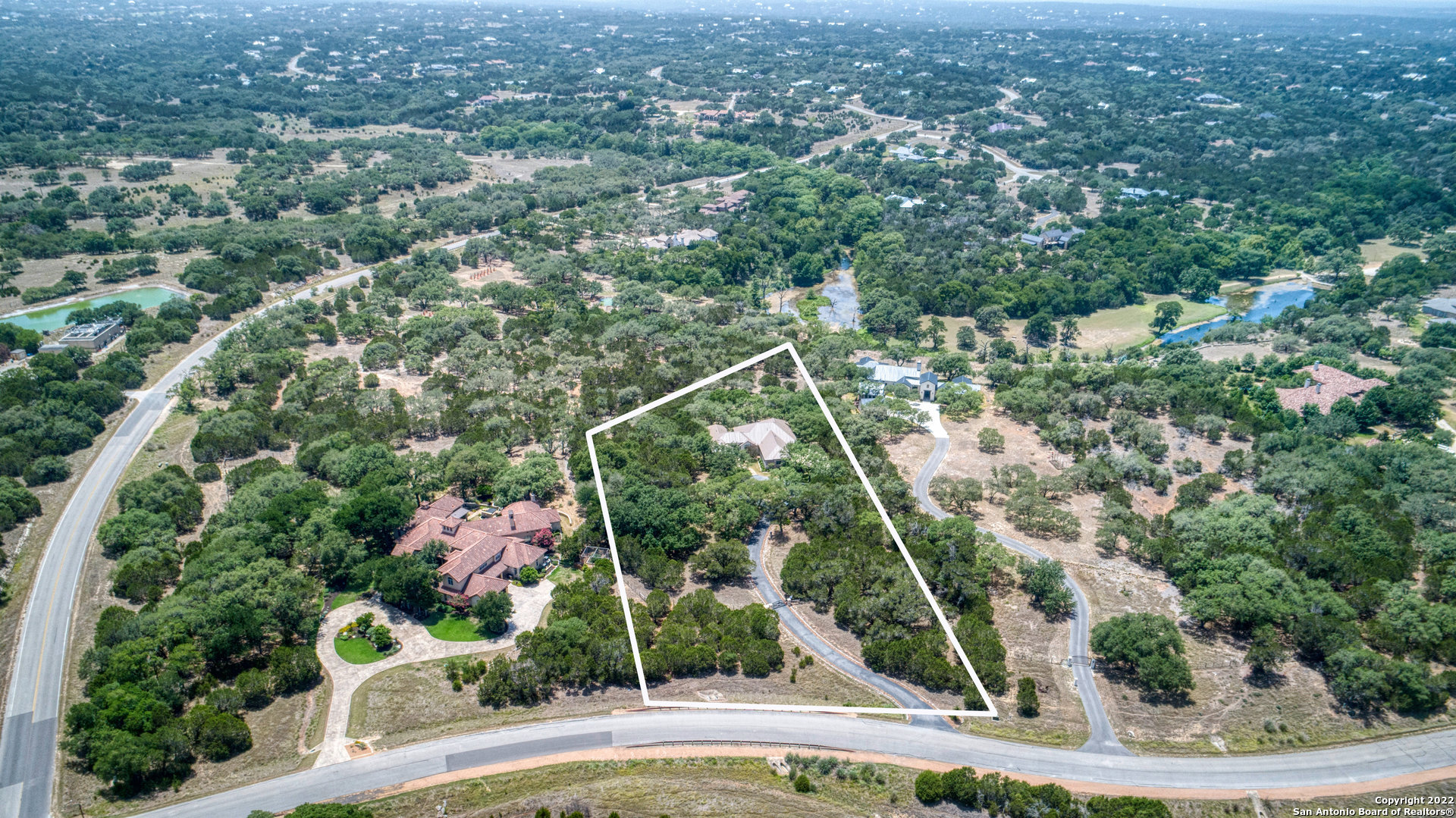 Stunning custom home on 3+ secluded acres in the Texas Hill Country's most exclusive country club community, Cordillera Ranch. Hill Country views of Swede Lake and Swede Creek Park characterize this premium location which features cul-de-sac privacy and multiple mature oak trees. This home is just a short walk to 66 acre Swede Creek Park and Cordillera's private Guadalupe River frontage. The open floor plan features granite counters, stainless Bosch appliances, custom cabinets and native stone accents. A spacious summer kitchen and covered outdoor living space created the ideal venue for family gatherings and entertaining guests. This home also features central water, sewer and high-speed fiber optic service.