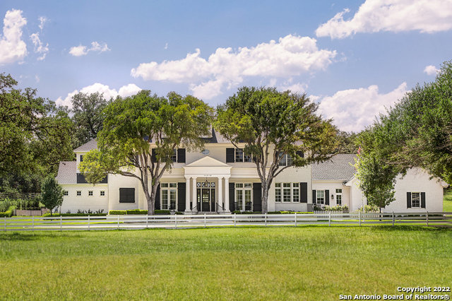 Unlike anything else you can find today in San Antonio's luxury market, this recently built Hill Country Village Estate is ready for the pages of any magazine: a true showpiece. Built by Nic Abbey in 2018, this magnificent, gated estate was designed by Courtney Balsam. Located on just over six acres, 8,877 square feet of living space was dreamed up and crafted with a vision for everyday luxury. Owners will enjoy bright, bold accents, designer light fixtures, high ceilings, abundant natural light, plus stunning crown moldings and custom ceiling treatments throughout. A chic foyer with herringbone hardwood floors is flanked by the formal dining room and posh private study with fireplace. An expansive family room serves as an ideal place to gather and flows seamlessly into the well appointed kitchen showcasing bespoke cabinetry, a commercial-grade gas range, and flawless natural stone counters and accent wall. This floor plan also includes a spacious butler's pantry, home gym, magnificent owner's suite with a spa bath and French doors, play room (or second office), game room, plus a generously sized flex/family room upstairs. With too many hidden gems inside to mention, the back yard is another beautiful escape, featuring an outdoor kitchen, fireplace, dual covered sitting areas, and pool with a spa. With grounds that offer a picturesque tree-lined drive as you enter, a scenic front porch, a fully irrigated and fenced garden bed, a great playscape, tons of fantastic sitting areas, and beautiful oak trees throughout, you'll never want to leave.