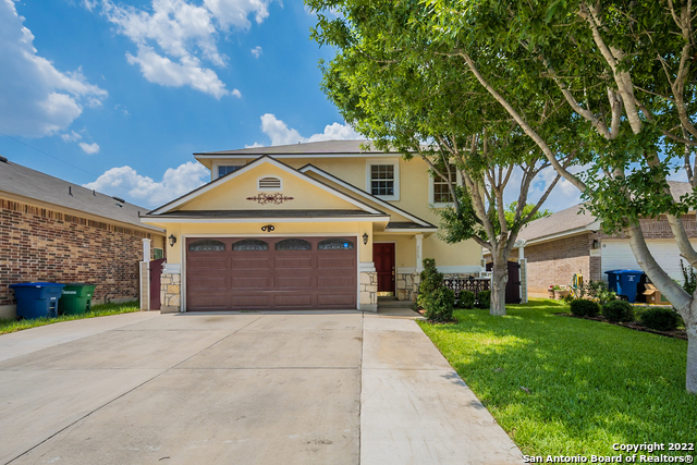 This San Antonio two-story home offers a patio, granite countertops, and a two-car garage.