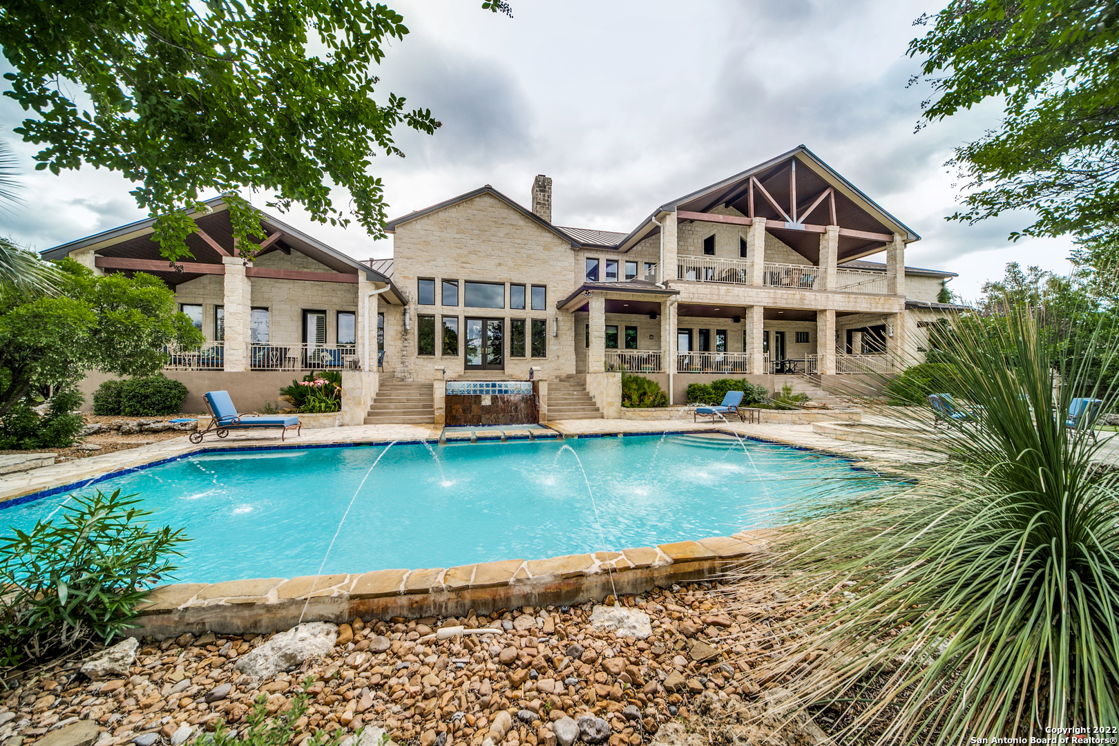 Majestic Custom Estate in the prestigious Cordillera Ranch sits on 4.5+acres. The stately entrance draws you in to the grand hallway filled with light, picturesque windows, and Hill Country views! The impressive space offers both formal and informal rooms catering to many different styles of entertaining and highlighted by the remarkable game room and large media room. The chef's kitchen boasts a double island, upscale stainless-steel appliances, Five Star 6 burner cooktop, double Dacor ovens, Sub-zero side by side refrigerator/freezer and a butler's pantry for the ultimate host! Master suite features lavish sitting area with a dual-sided wood-burning fireplace, stepped ceiling, outside access, and a spa-like bath complete with separate vanities, jetted tub, and walk-in shower. The well-appointed private study, downstairs guest room and spacious secondary bedroom suites complete the interior of this home. Step outside for breathtaking views and an elevated resort-like setting to entertain or simply relax in luxury featuring covered patios, pool and spa with waterfalls, putting green, fire pit and Biergarten for all your outdoor culinary needs. This is Hill Country living at it's BEST!
