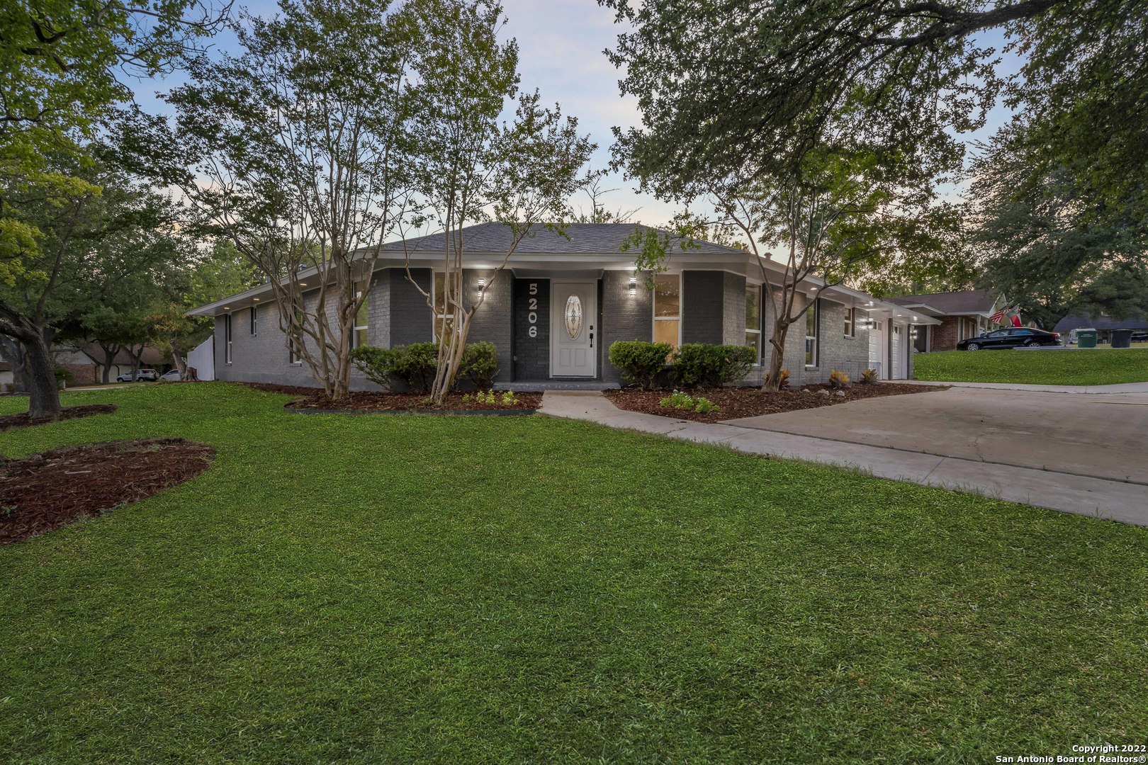 This elegant 4-bed, 2-bath single-story home sits on a spacious 0.35-acre corner lot on a tree-lined street in highly desirable Northern San Antonio, just minutes from the medical center with a full TWO-CAR GARAGE! The thoughtfully landscaped grounds with mature trees invite you into the front yard. Upon entrance, you are warmly greeted by a brick fireplace, fresh paint, and meticulous attention to detail in the kitchen with new granite countertops, customized backsplash, and brand-name appliances in all stainless steel, including the kitchen hood, oven/range, and dishwasher. The oversized owner's suite is complemented by a completely renovated bathroom and rainfall shower! The backyard is full of FUN! There is a large patio that provides plentiful space for gardening and entertaining. There includes an entire battery of new upgrades, including but not limited to: a new roof as of January 2022, new kitchen and bathroom cabinets, new tile flooring, faucets, completely remodeled kitchen and bathroom granite countertops, new backyard and chimney siding, new A/C unit and compressor with new ducts, new plumbing lines, lights, outlets, and ceiling fans. All windows, doors, and garage door openers are new, and bedrooms include closet organizers and new shelves. The attic is equipped with new blowing insulation, a new gas water heater, smoke alarms, a fuse box with breakers, and more--all recently replaced between March and June of 2022.