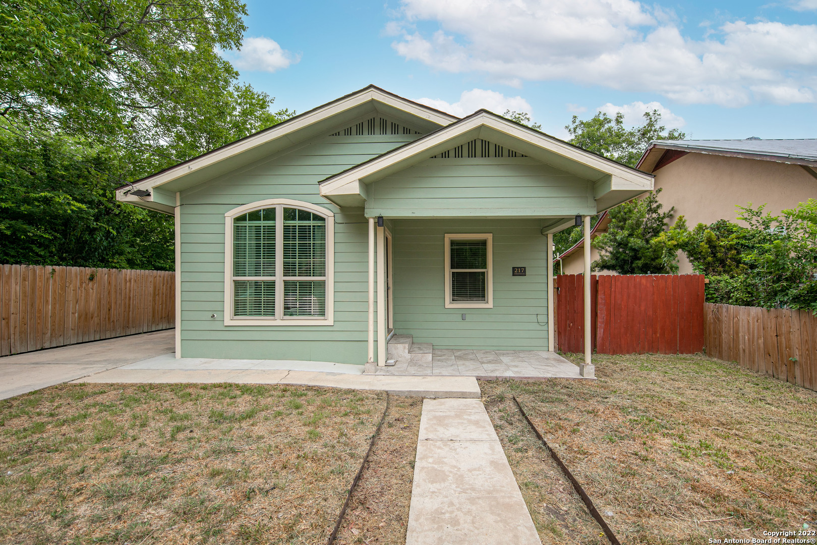 Beautifully renovated in 2020, this classic bungalow is perfectly located just 10 minutes from Downtown San Antonio! The interior is light and bright with elegant ceramic tile flooring throughout the entire home - no carpet anywhere! The entry leads you to a living/dining combo accentuated with upscale crown molding that opens to the chef's kitchen featuring granite countertops, sleek stainless-steel appliances, and a large breakfast bar with additional storage space. Near the kitchen is an additional dining area with a modern light fixture where you can host family and friends for festive meals. The primary suite is huge with a lovely tray ceiling, LED recessed lighting, a large walk-in closet, and a spa-like en-suite well-equipped with a granite-topped dual vanity, vessel sinks, and a frameless walk-in shower. The secondary bedrooms are well-sized and include private bathrooms. The backyard offers lots of space for outdoor activities and features a wood privacy fence and a covered patio where you can lounge in the shade or grill with friends on a sunny day. Easy access to area schools, shops, restaurants, grocery stores, and everything San Antonio has to offer. Schedule a showing today!