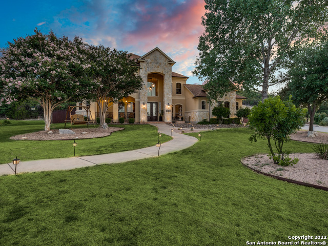 This gorgeous estate boasts stunning hill country views with meticulous interior finishes creating the essence of luxury. Inside, a grand entrance guides guests through the open floor plan showcasing views of the wrought-iron staircase, picture windows with plantation shutters, and soaring ceilings. Off the entry, the formal dining space allows for elegant dinner with the convenience of a pass-through to the gourmet kitchen. The kitchen offers custom cabinetry, complementing granite counters, a stylish backsplash, and a walk-in pantry. Views of the outdoors are provided in the breakfast nook. The living space offers a stone fireplace and ample room for a sectional, perfect for comfortable seating. The primary offers tray ceilings and ample natural lighting. The en suite is accessed by double doors and has a walk-in shower, soaking tub, a sit-down vanity, and dual sinks. This property also has four spacious bedrooms, each with walk-in closets. The game room and dedicated movie room create multiple avenues for entertaining. Outside, the backyard oasis features a heated salt water pool with an adjacent spa. Native landscaping, solar panels, and drip irrigation garden beds give the home a sustainable footprint. Close to I-10, major grocers, and eateries, come see this Magnificent home today.  Open house Sunday 7/31, 1:00 to 3:00 PM.  Mimosas and Snacks will be served.