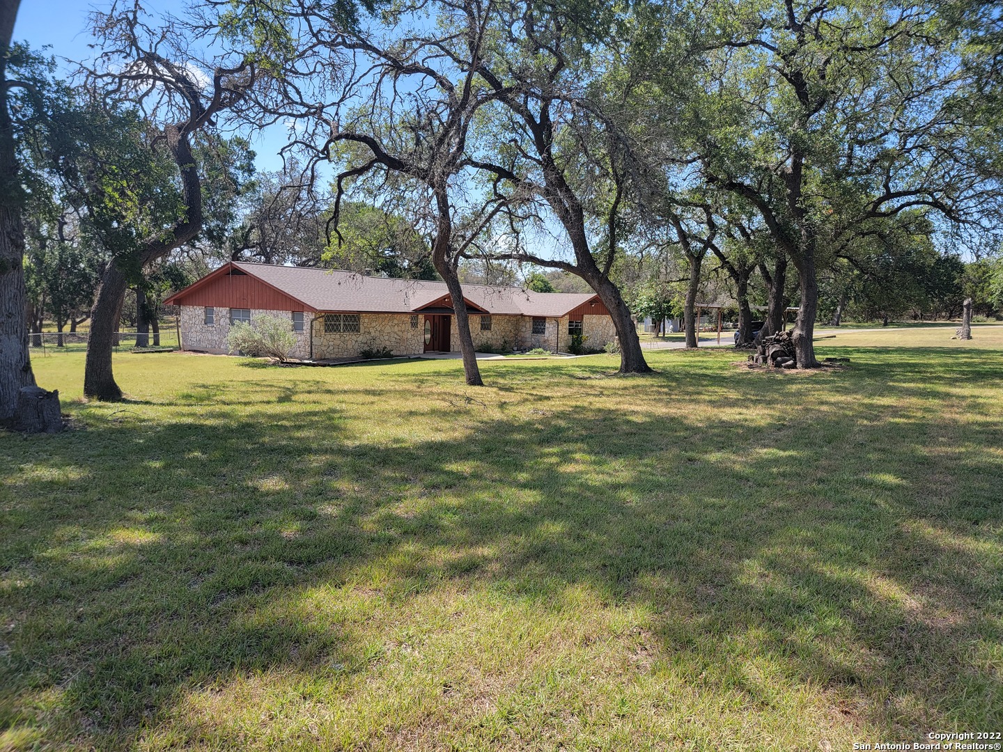 6 ACRE Lot in Boerne, you can have Horses!! Wow! This 4/3/2 home is country living at its finest! This home offers all the convenience of a modern home, yet has a distinct tasteful country feel. The focal point of the home is the living room boasting lots of character with vaulted ceilings, fireplace and stone accent wall. There is a sunroom just of the living room that may serve as second living area with two sliding glass doors providing a view of the covered deck and rear yard. Then step down into a third living area, the den, featuring an antique wood burning fireplace and a sliding glass door allowing access to the deck. The kitchen is spacious offering recently installed cabinets, granite countertops, and stainless steel appliances. The oversized two car garage is ideal for a workshop. Other features include a guest bedroom with a private bath, recently installed roof, foundation repairs, laminate wood flooring, plush carpet, fresh paint, electric gate at entrance to property, an above ground pool, horse stalls/large shed, mature trees and more. Come see for yourself. You won't be disappointed !