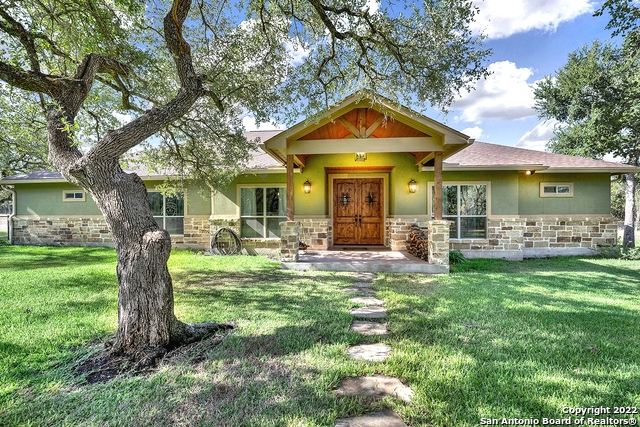 Hondo Texas country stunner!! Custom build on 10 acres covered in mature trees. This 3000 plus square foot stucco/rock home is absolutely gorgeous with it's adjoining pool and spa and beautiful covered back porch. Inside the double front doors you will find 4 bedrooms - one could be used as an office, 3 full bathrooms, vaulted living room ceilings, a massive rock fireplace, open concept and phenomenal layout! Some of the extras outside include a 3 car carport, a well, garden, 40x40 Mueller barn, RV covered parking, a storage shed, sprinkler system and so much more! Meticulously maintained and set up perfectly. Country living at it's finest just minutes from town!