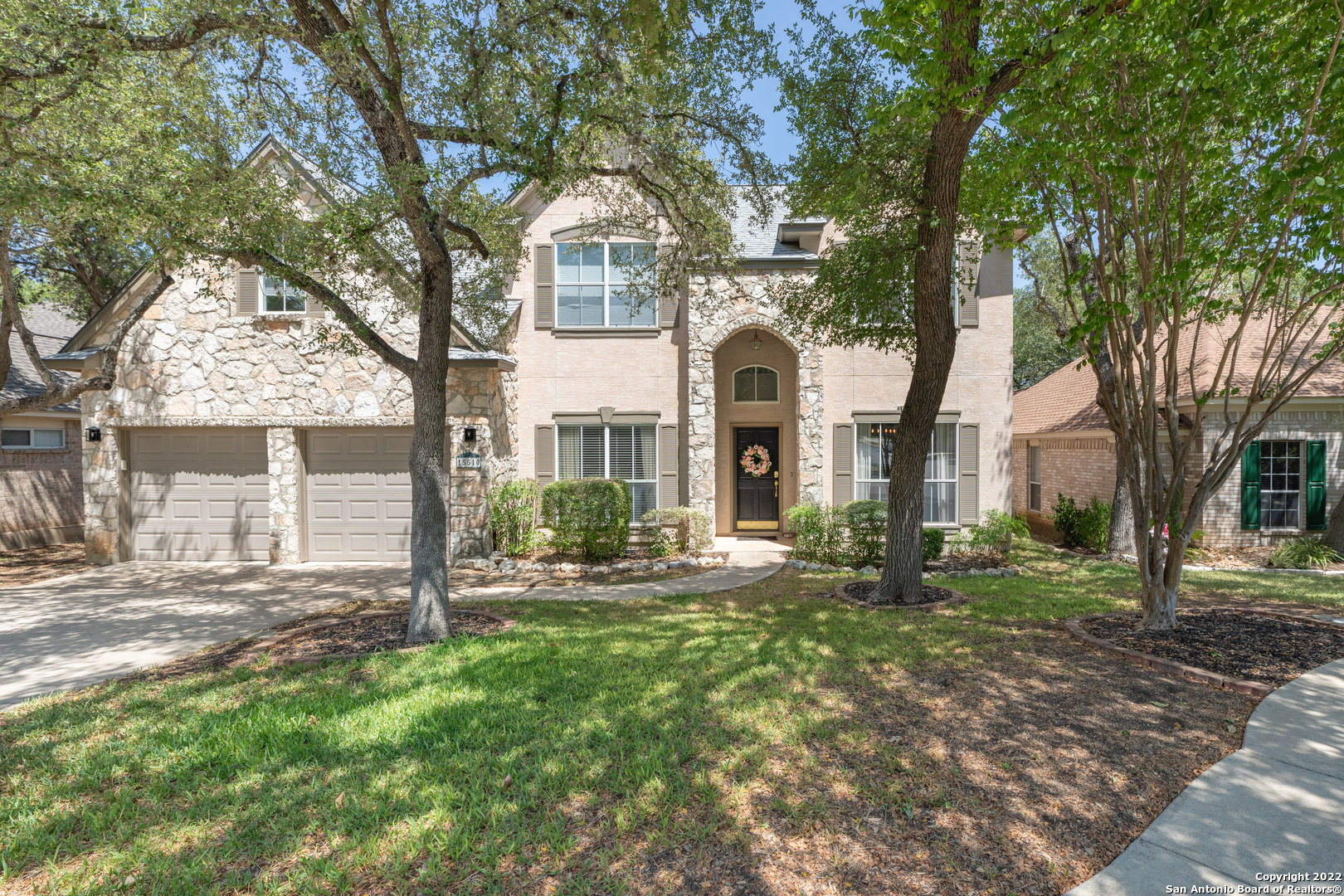 Welcome to your new custom 3 bedroom and 2.5-bath home in this prestigious gated Deerfield neighborhood. Great NEISD schools. Minutes from 281, 1604, and shopping. This home is on a scenic greenbelt. The main level features an open floor plan with tile and wood floors throughout and large windows for natural light. There are two living spaces on this level, with the family room featuring a fireplace and outside access to the quiet, wooded backyard. The gourmet kitchen has beautiful granite countertops, stainless steel appliances, plenty of oak cabinet space, and built-in microwave, oven, and cooktop. The large master suite and master bath are downstairs, with dual vanities, a separate garden tub and shower, and two walk-in closets. The second level has two additional bedrooms, a bath with double vanity and shower tub, and a large game room with beautiful wood floors. Your backyard with a large deck and mature oak trees is ideal for entertaining and relaxation. Do not miss out on this remarkable home.