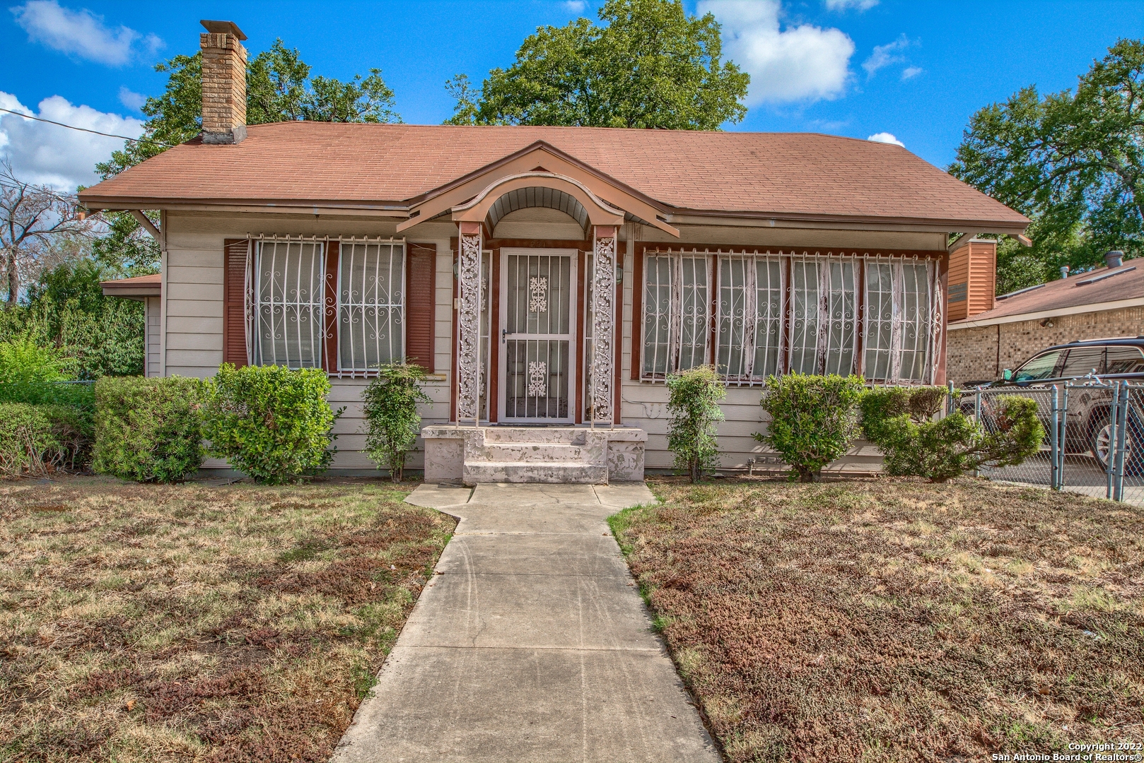Vintage home in Denver Heights just off So. New Braunfels. Convenient to downtown, Alamodome, AT&T Center, IH10, IH35, and IH37, Ft. Sam Houston & more.  This 1927 home has good bones but needs some TLC and is being SOLD AS IS. Carpet in LVR, DR, and front bedroom was recently removed to show the original hardwood floors. This 3 Bedroom/2 bath, home includes a large Den/Family RM. Plus, just off LVR is a bonus room that could be used as an office or other living space. Den/Family RM could also be a primary bedroom with a private bath.  Small rear bedroom next to laundry room could also be an office, playroom, or exercise room it's up to you. Living room features wood burning fireplace and built ins. All appliances convey. Roof - 10 yrs old, 40-gal water heater - 10 yrs old, AC - 5 yrs. old, Security System conveys. Only street parking available. Two large pecan trees give ample shade for the backyard.  Many new builds going on in this area.  **CHANDELIER IN DINING ROOM AND EXTERIOR HANDICAP RAMP DO NOT CONVEY**