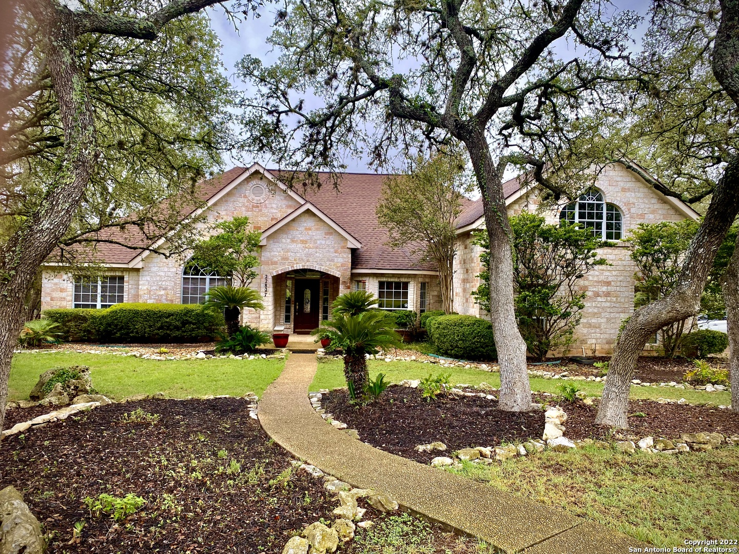 Welcome to your Hill Country Oasis right in the heart of Stone Oak. Tucked into a prestigious gated community, The Forest At Stone Oak, this beautiful home sits on over an acre with 100 classic oak trees. Spacious open floor plan has designer tile throughout, cathedral ceilings, spectacular fireplace and huge windows overlooking the private covered patio and outdoor fireplace. Fresh paint inside and out. Roof replaced in 2016. Ranch-like backyard has a firepit perfect for bonfires and cocktails under the stars. Luxurious Master Suite and spa like bath has a huge jetted soaker tub. All bedrooms are on the main floor. Guest bath completely renovated and tub surround includes designer tile to ceiling. Upstairs bonus room with half bath is perfect for Kids retreat or media room. Breakfast area and island kitchen, with stainless steel appliances including a double oven and a 5 burner gas cook top, makes entertaining a dream! The neighborhood pool is directly across the street...so it's like having your own without the upkeep!!! If you haven't seen this Amazing Neighborhood, You need to schedule a showing appointment and come see it!