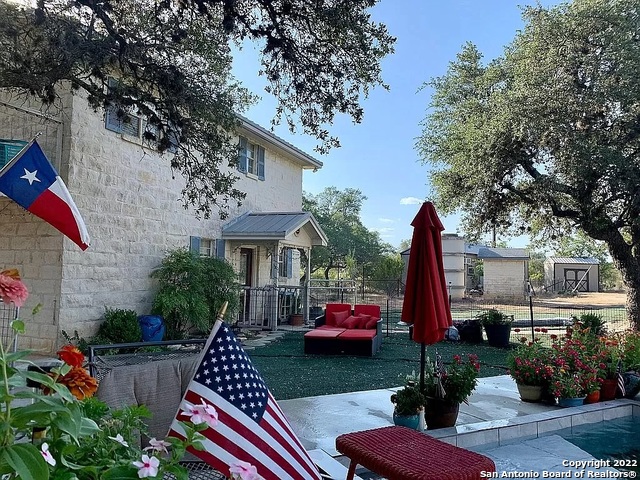 Pipe Creek, TX is 11 miles away from Bandera, the "Cowboy Capitol of Texas" and 5 miles away from Medina Lake.  This custom limestone home brings in features that match the rustic beauty the area has to offer.  Take in the 8+ acre view from the upstairs living space. With a unique hill country floorplan this home has a fireplace, half bath, dining room, laundry, and kitchen on the second story providing easy access to the master bedroom/bath, 2 spare rooms, and an additional bath downstairs. Watch the sun rise on one side of the half-wrap porch and later enjoy the stunning sun set on the other half.  Entertain family and guests under the 15x15ft covered/screened in grilling patio that includes a smoker, fridge, freezer, and sink. The 12x11ft dipping pool is separate from the rest of the backyard allowing for uninterrupted enjoyment from pets, livestock, and wildlife.  There is a second living space on the property with it's own backyard. The 1/1 Derksen portable building has been converted into a small cabin that's 640 sq ft with a laundry closet, kitchen, and living room. This is the perfect space for a family member, guest house, or would make a great home office.  By joining the unrestricted, voluntary HOA, you will have the access code to river access complete with on-site grills and picnic tables.  Don't miss this incredible opportunity to have your own secluded Texas Hill Country hideaway!    Septic pumped in 2021  New HVAC and water heater