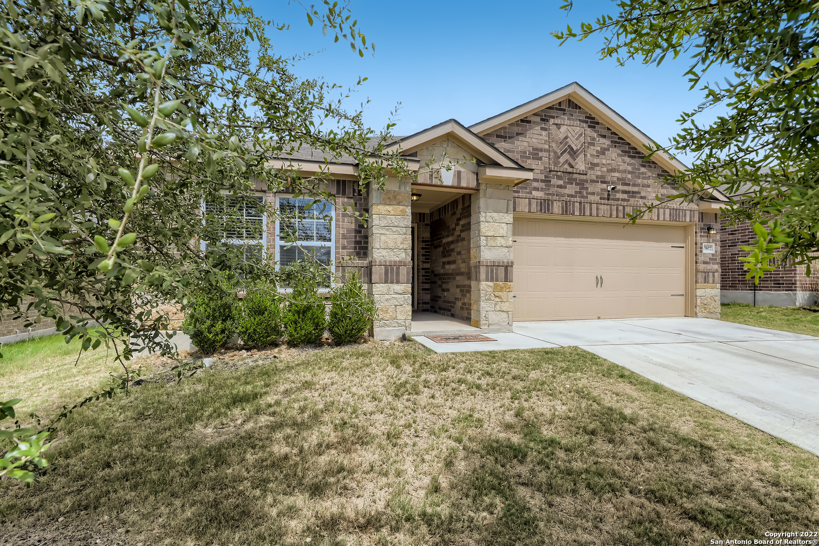 Click the Virtual Tour link to view the 3D Tour. Lovely one story brick and stone home just built in 2018 about 30 minutes from downtown San Antonio. Dark wood cabinets and granite countertops line this spacious kitchen with a built in breakfast bar and kitchen island. The kitchen has a great view of the eating area and living room, you'll never miss any of the action here! The dining area has a gorgeous chandelier and has a great view of the covered patio in the fenced in backyard. The master closet is everyone's dream with tons of built in shelving. Don't forget to take advantage of the many amenities provided by the Talise De Culebra community including the sparkling pool, huge clubhouse, fun playground and lovely walking trails.
