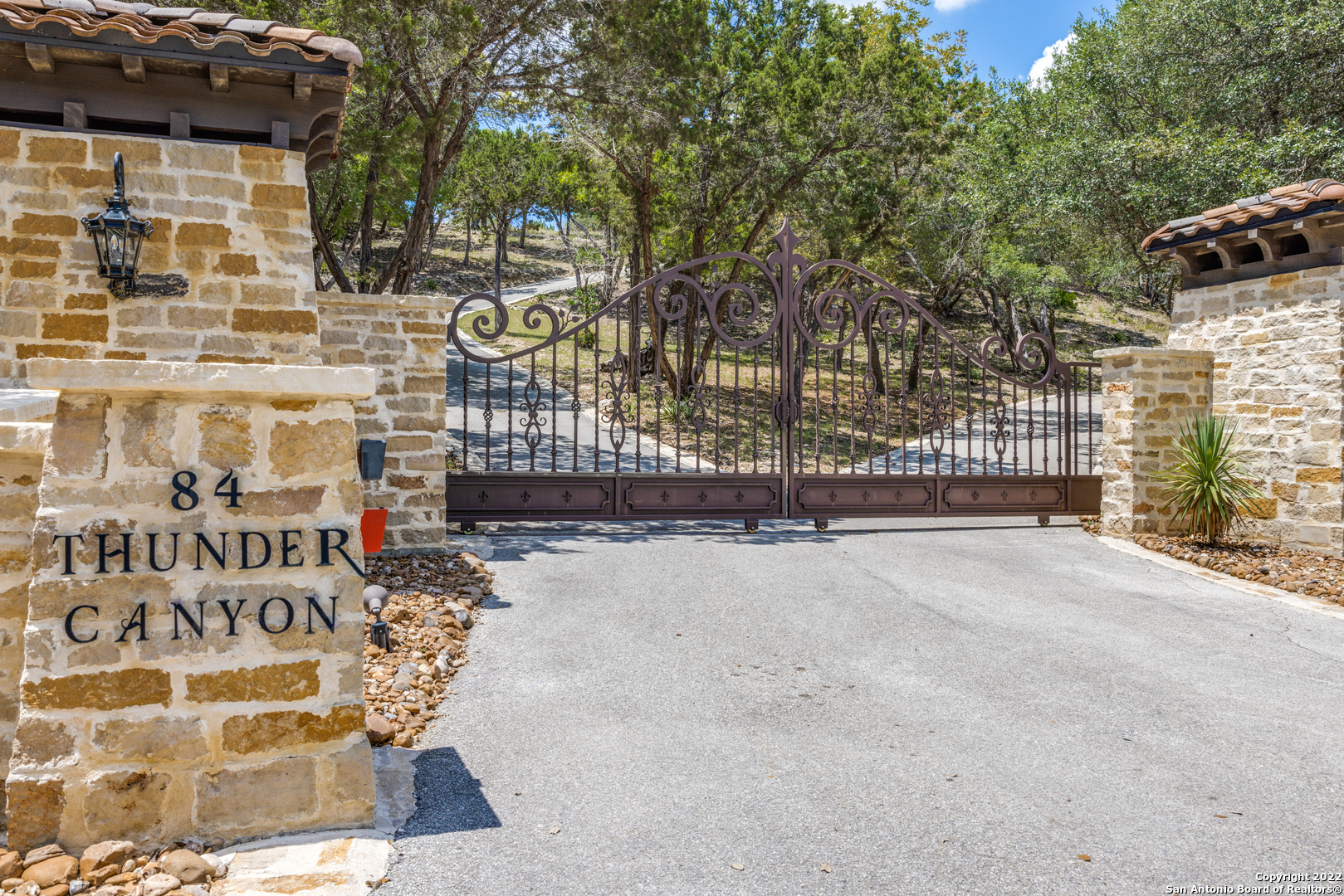 Spectacular Hill Country views from this Elegant, Privately Gated and Secluded 9.29 Acre Estate.  Once in Estancia you will fall in love with the hill country charm.  Enter the estate through the wrought iron gates, follow the road to the top of the hill and you will be met with a view of the city and this exquisite home.  The double wrought iron doors will welcome you in and you will be able to see the breath-taking views from most every room of the house.  The chef's kitchen with professional chef's grade stainless steel appliances, island and sitting/serving bar for 8 open to the family room by a stone archway. The family room boast floor-to-ceiling fireplace, wall of windows allowing an abundance of natural light, gorgeous ceiling treatment, stunning wood floors and a wrought iron gated wine cellar/storage.  3-spacious secondary bedrooms, all with en-suite bathroom and walk-in closets. Secluded game room with windows and a large sliding glass entrance to the outdoor patio. 3-car garage with extra storage. The private north wing offers a spacious primary bedroom with hill country views and its own access to the outdoor oasis.  The split floorplan allows options with a study/nursery or secondary bedroom to be part of the north wing.  Double vanity, oversized walk-in closet, luxury shower and spa tub make this en-suite a five-star experience.  Make a splash in the infinity edge pool & spa in the resort-style outdoor paradise or just relax on the large, covered patio overlooking the spectacular panoramic views of the hill country.  Estancia offers ag. exemption plus 50,000 sq ft covered equestrian center, gym, workout room, skeet range, 3 par 3 practice golf holes, 5-acre fishing lake, covered pavilion & a kitchen, gas grills & fireplace. Just minutes to Boerne, restaurants, shopping, hospitals and airport.