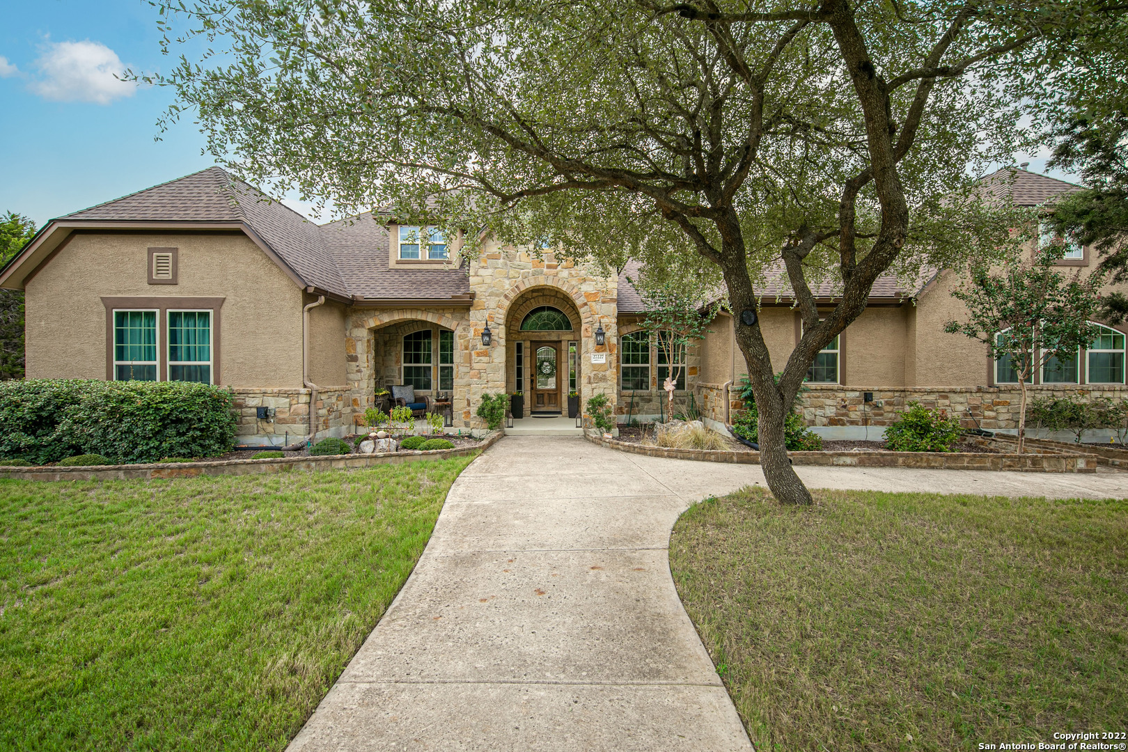 Nothing but beautiful, peaceful Hill Country living with this gorgeous custom home that sits on a 1.5-acre treed lot!  Located in the prestigious Rockwall Ranch community, this spectacular home features an open concept living space with the kitchen at the heart of it all!  Beautiful custom cabinets, a huge granite island, and quick access to the backyard make this an entertainer's dream.  The large outdoor covered patio and newly built seating area with a pergola are perfect for enjoying fall evenings outside. With the vast amount of private outdoor space this property offers, an additional dwelling or pool would be the perfect addition! The roomy master suite boasts separate his and hers walk-in custom closets, a garden tub and walk thru shower.  A game room and separate study allow for family fun and privacy at the same time.  Other features in this home include hand-scraped hardwood floors, a 3-car garage with epoxy floors, and a cozy sunroom. Conveniently located within a short distance of the neighborhood pool, playground and sports courts.