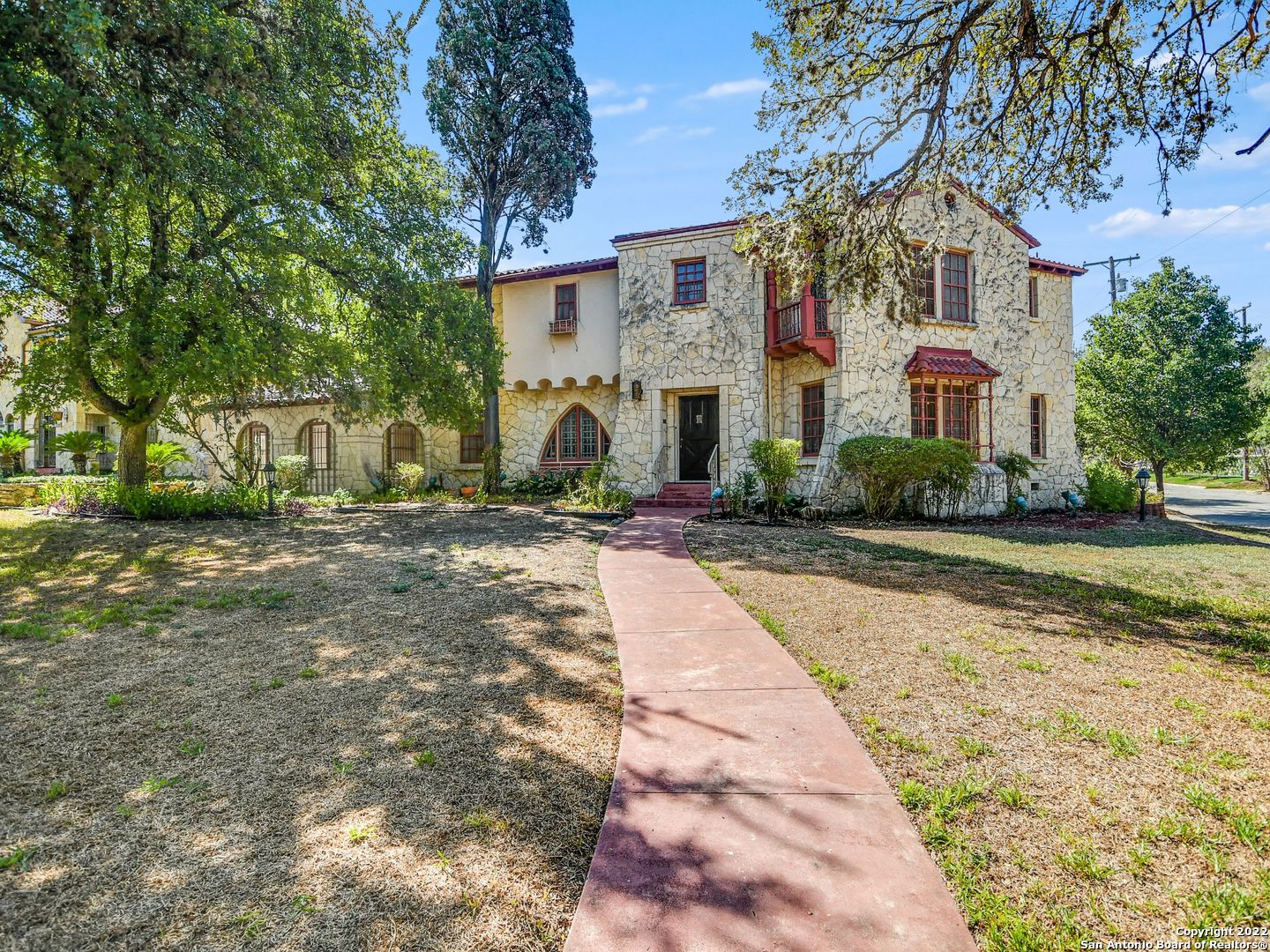 Located on the most coveted block on West Kings Highway in Monte Vista, this two level, stone exterior, 3234 square foot home is available for sale after 50+ years of ownership. This 1910-built home is solid as a rock structurally with unique architectural details. The original wood floors are throughout the house. First level features a formal living, dining and study space, a sun room and additional family room overlooking the patio and backyard. Kitchen is prime for a renovation. Up the beautiful spiral stairs with stained-glass window to the second level is your primary suite, two, large secondary bedrooms and a full bath. There is an attached two-car garage. The 0.375 acre corner lot could allow for a home expansion and / or a pool / casita addition.  The home has been well maintained.  Enjoy as-is or have a blank canvas to design your dream space.  Being sold as-is with inspection report available.