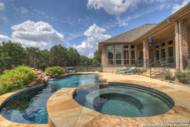 Entertainers dream! This gorgeous, one story, home has everything you could hope for. From the stunning, spacious kitchen, to the picturesque in ground pool with spa and waterfall feature, this lovely home is an opportunity to have your very own piece of Hill Country Heaven! This home offers 4 bedrooms; Primary bedroom with ensuite, soaker tub, separate large shower, his/hers closets, expansive windows allowing tons of natural light and space for a sitting area. Guest room with ensuite offers a walk in closet secluded from the other bedrooms. There is an office and media room as well. The outdoor space is amazing with an outdoor kitchen, large covered back patio, multiple seating areas, open patio space near the pool, a firepit, wrought iron gate in back yard allows you to keep your children and pets close but still have tons of natural landscaping, large oak trees and a peaceful green space get away! All this on 1 acre in the desirable gated community of The Preserve!
