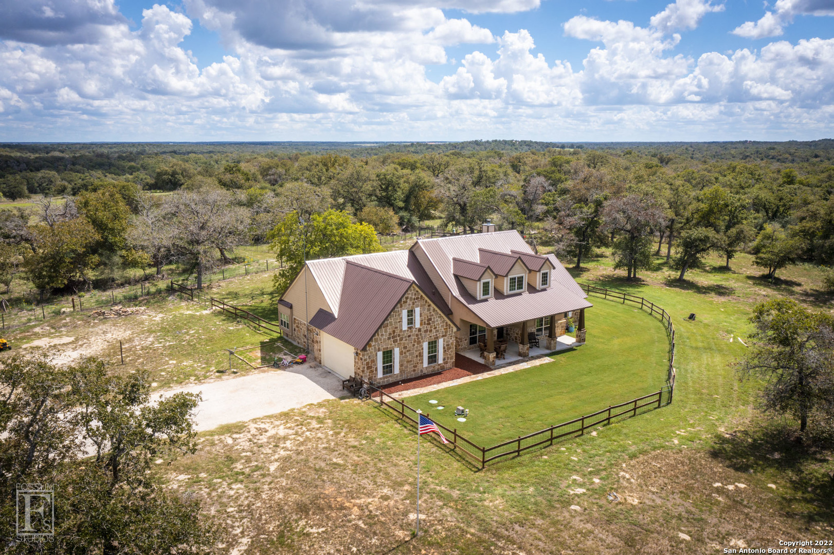 Beautiful 3 BR, 2.5 BA home+office home built in 2015 on 10 acres, hunting allowed. Rock & stucco exterior, metal roof, w/ a great inviting covered front porch, covered back porch, extended rock patio, garden area & hot tub.The property is completely fenced w/ electric drive through gate, sprinkler system & sodded around the house, property on a well, water softener & SOLAR PANELS! Head inside this 1 story home, to the right is a large study, to the left an open formal dining space. The large master suite is conveniently located across from the utility room. Large master bath with huge walk in closet. On the other side of the house are 2 add'l guest BR w/ a shared guest bath, plus a computer desk nook. The living room & kitchen are open to each other, the back wall is lined w/ windows, great views & lots of natural sunlight, wood burning fireplace w/ stone surround, concrete floors, large kitchen w/ warm wood cabinetry, granite countertops, double wall Electrolux ovens & dishwasher, electric cook top, built in convection microwave. The covered back patio gets afternoon shade, extended rock patio, hot tub conveys.  Gardens, chicken coups, 100x100 dry tank, ranch fencing, mature trees, secluded!